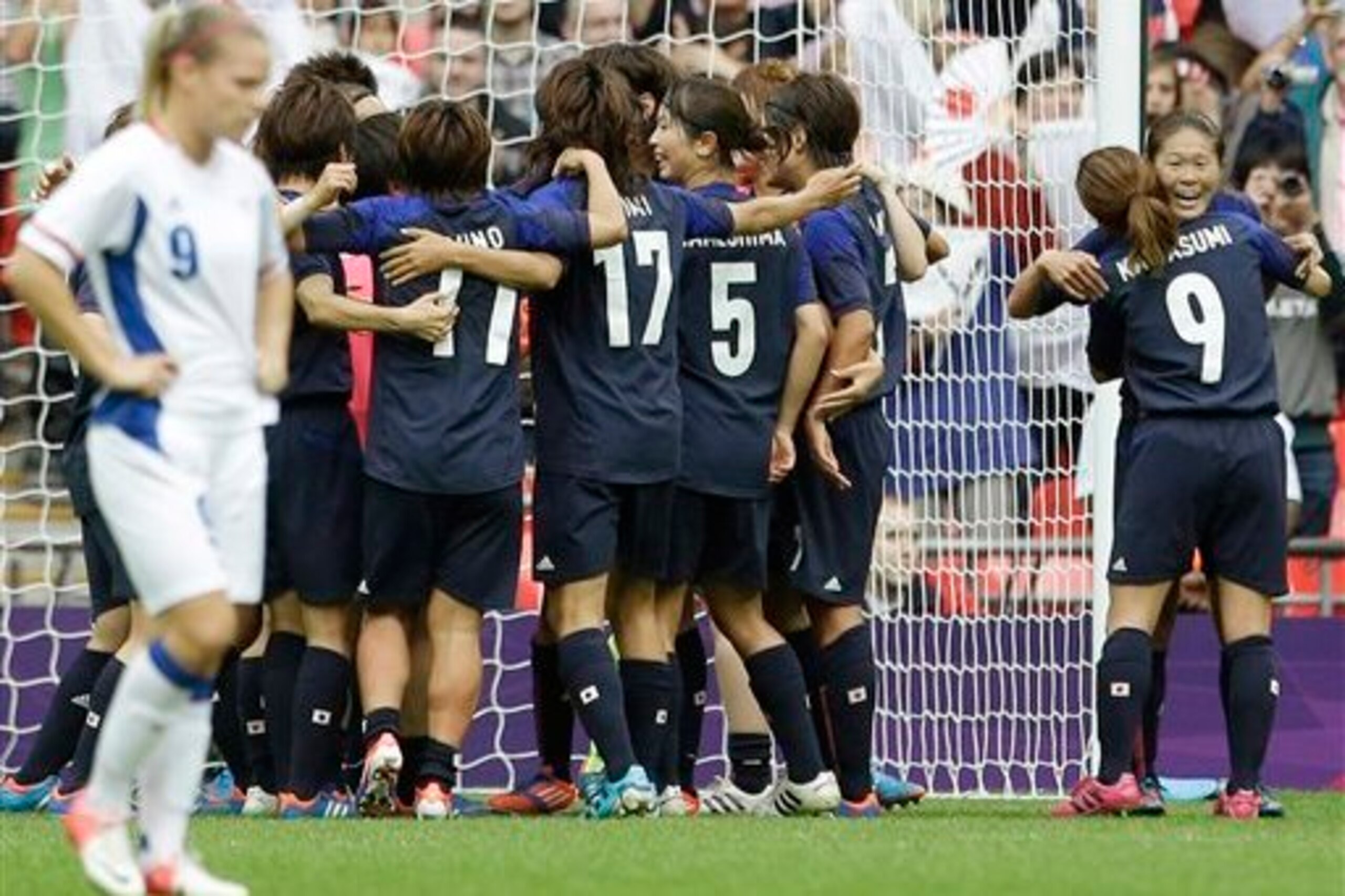 Le Sommer distraught as Japan celebrate their win in 2012.