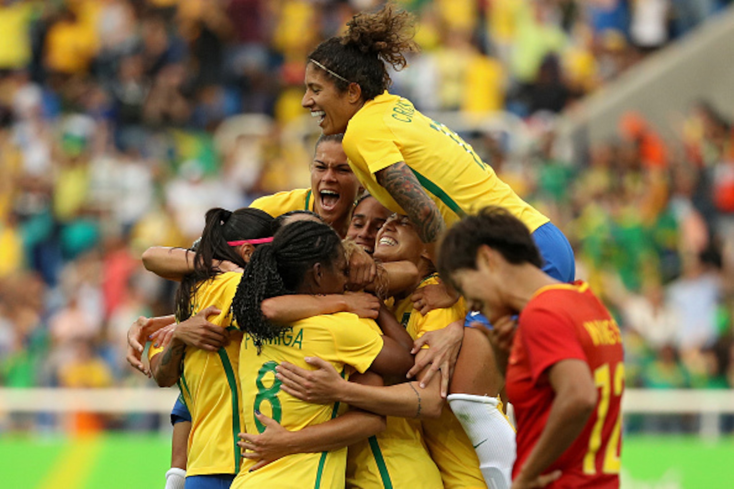 RIO DE JANEIRO, BRAZIL - AUGUST 03:  Monica of Brazil (3) celebrates with teammates 
after she scored their first goal during the Women's Group E first round match against China PR during the Rio 2016 Olympic Games at the Olympic Stadium on August 3, 2016