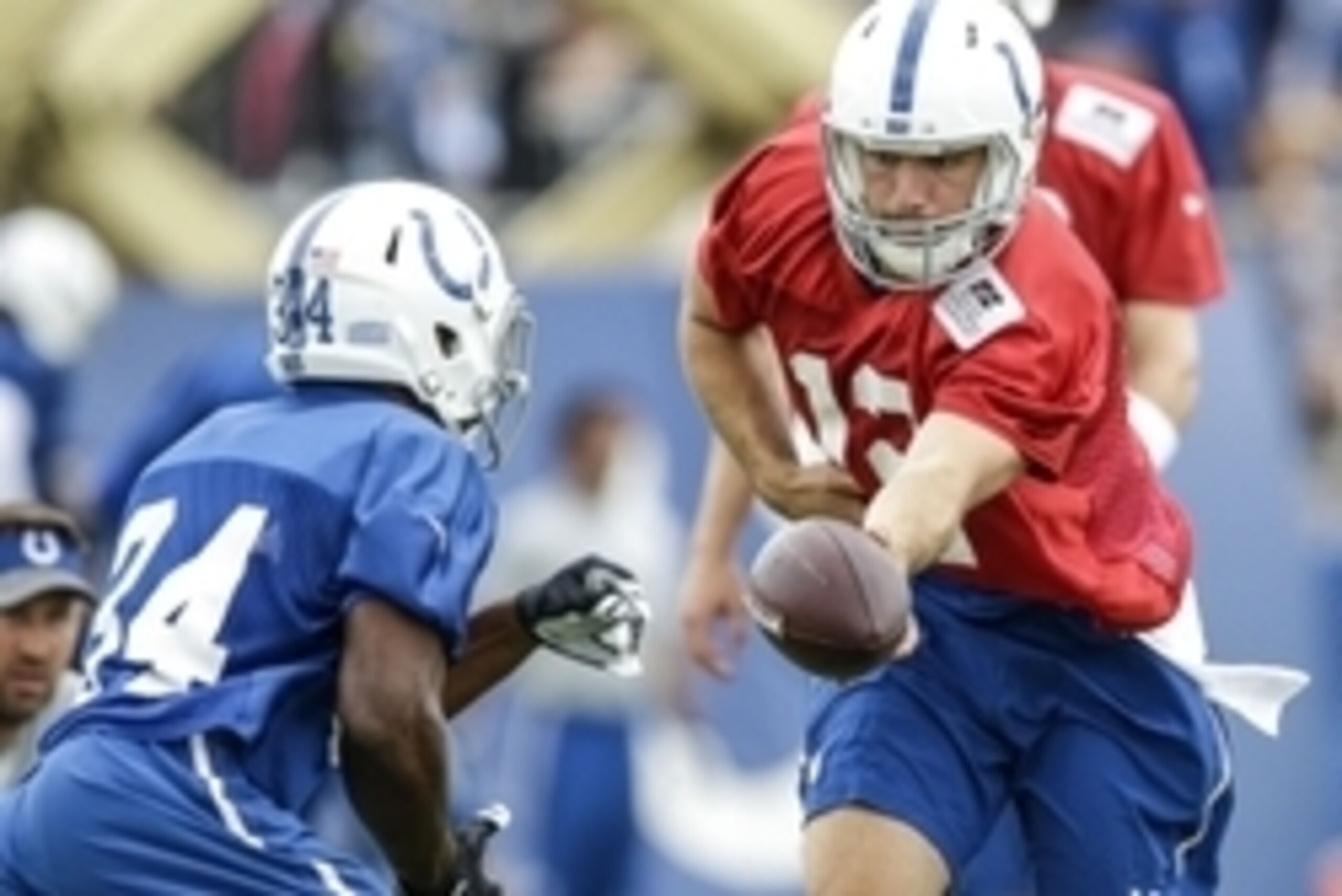 Jul 28, 2016; Anderson, IN, USA; Indianapolis Colts quarterback Andrew Luck (12) hands off to running back Josh Ferguson (34) during the Indianapolis Colts NFL training camp at Anderson University. Mandatory Credit: Mykal McEldowney/Indy Star via USA TODA