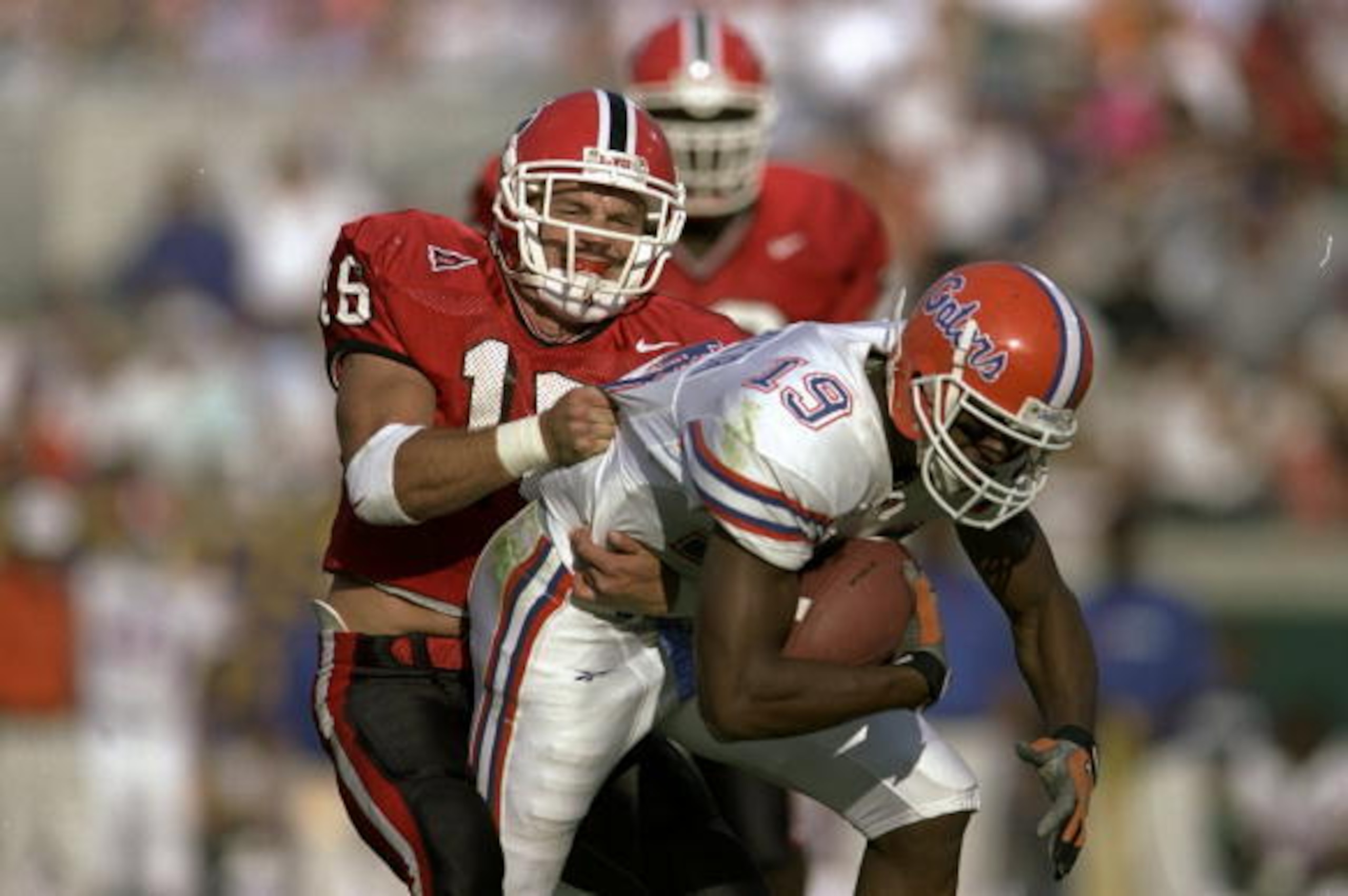 31 Oct 1998: Travis Taylor #19 of the  Florida Gators grips the ball as he is tackled by Kirby Smart #16 of  the Georgia Bulldogs at Alltel Stadium in Jacksonville, Florida. Florida defeated Georgia 38-7. Mandatory Credit: Andy Lyons  /Allsport