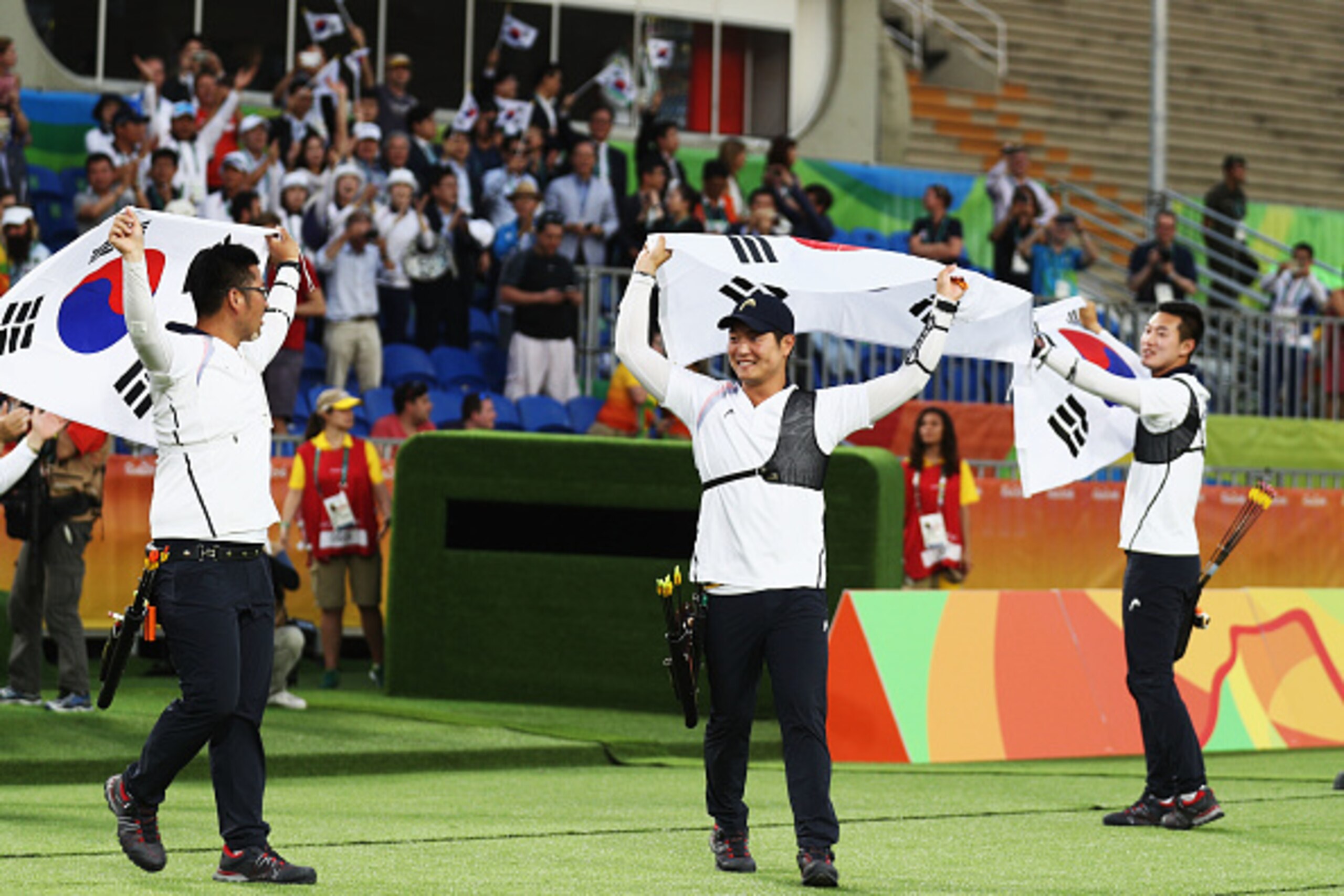RIO DE JANEIRO, BRAZIL - AUGUST 06:  (L-R) Woojin Kim, Seungyun Lee and Bonchan Ku of Korea celebrate defeating the United States during the Men's Team Final match on Day 1 of the Rio 2016 Olympic Games at the Sambodromo on August 6, 2016 in Rio de Janeir