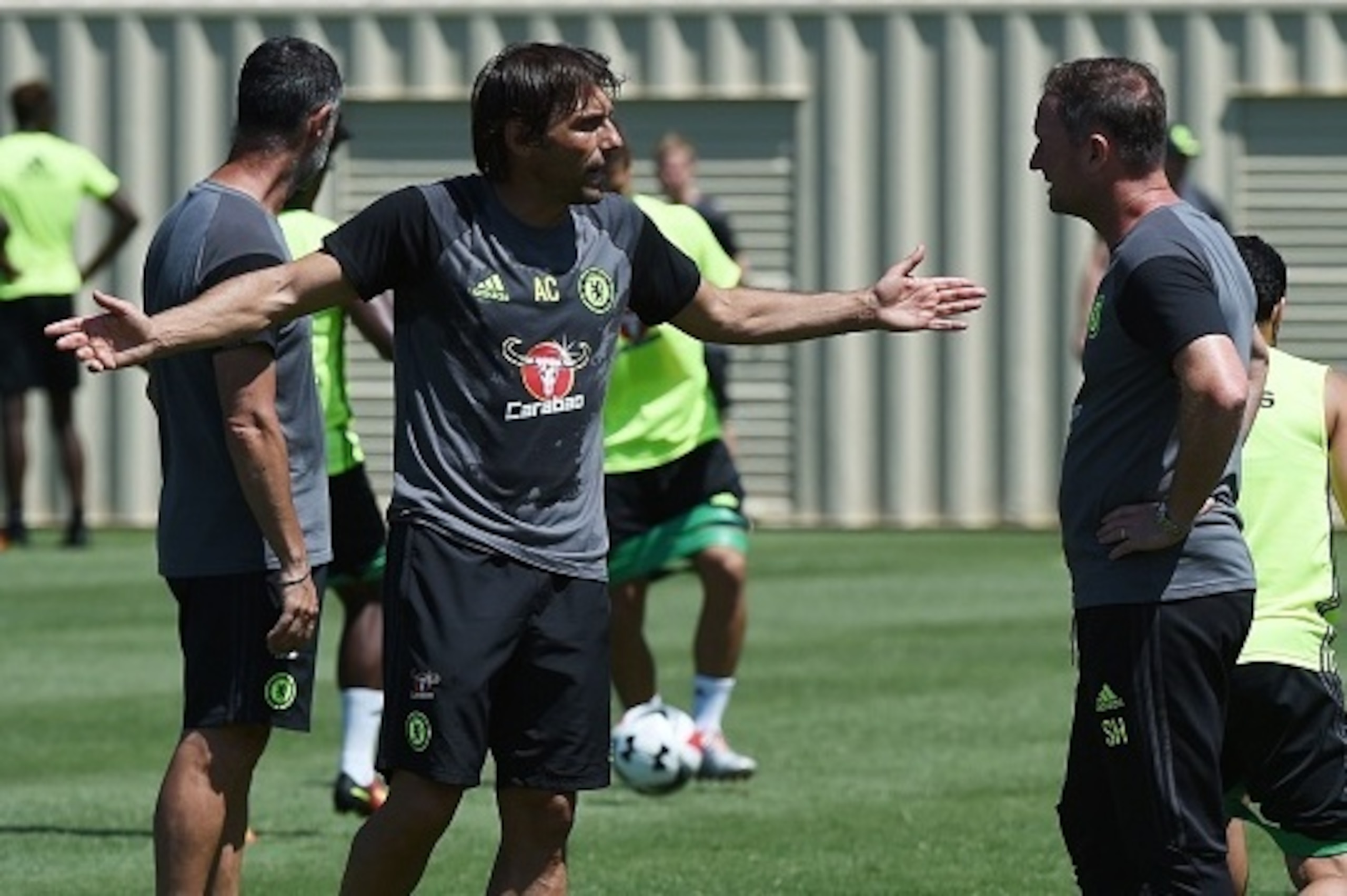 New Chelsea coach Antonio Conte (L) talks with an assistant during a training session before their International Champions Cup (ICC) game against Liverpool, at the UCLA Campus in Westwood, California on July 26, 2016.  
The two teams will meet at the Rose