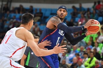 USA's forward Carmelo Anthony (R) holds on to the ball while facing China's forward Yi Jianlian during a Men's round Group A basketball match between China and USA at the Carioca Arena 1 in Rio de Janeiro on August 6, 2016 during the Rio 2016 Olympic Game