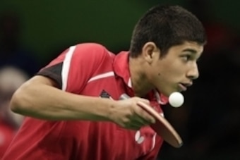 Aug 6, 2016; Rio de Janeiro, Brazil; Kanak Jha (USA) serves the ball to Nima Alamian (IRI) during the table tennis singles preliminary round at Riocentro. Mandatory Credit: Andrew P. Scott-USA TODAY Sports