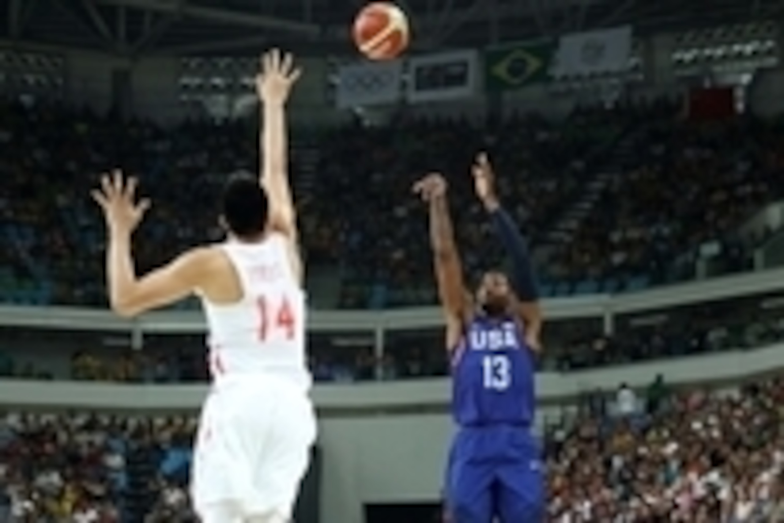 Aug 6, 2016; Rio de Janeiro, Brazil; United States guard Paul George (13) shoots the ball against China center Yuchen Zou (14) in the men's basketball group A  preliminary round during the Rio 2016 Summer Olympic Games at Carioca Arena 1. Mandatory Credit