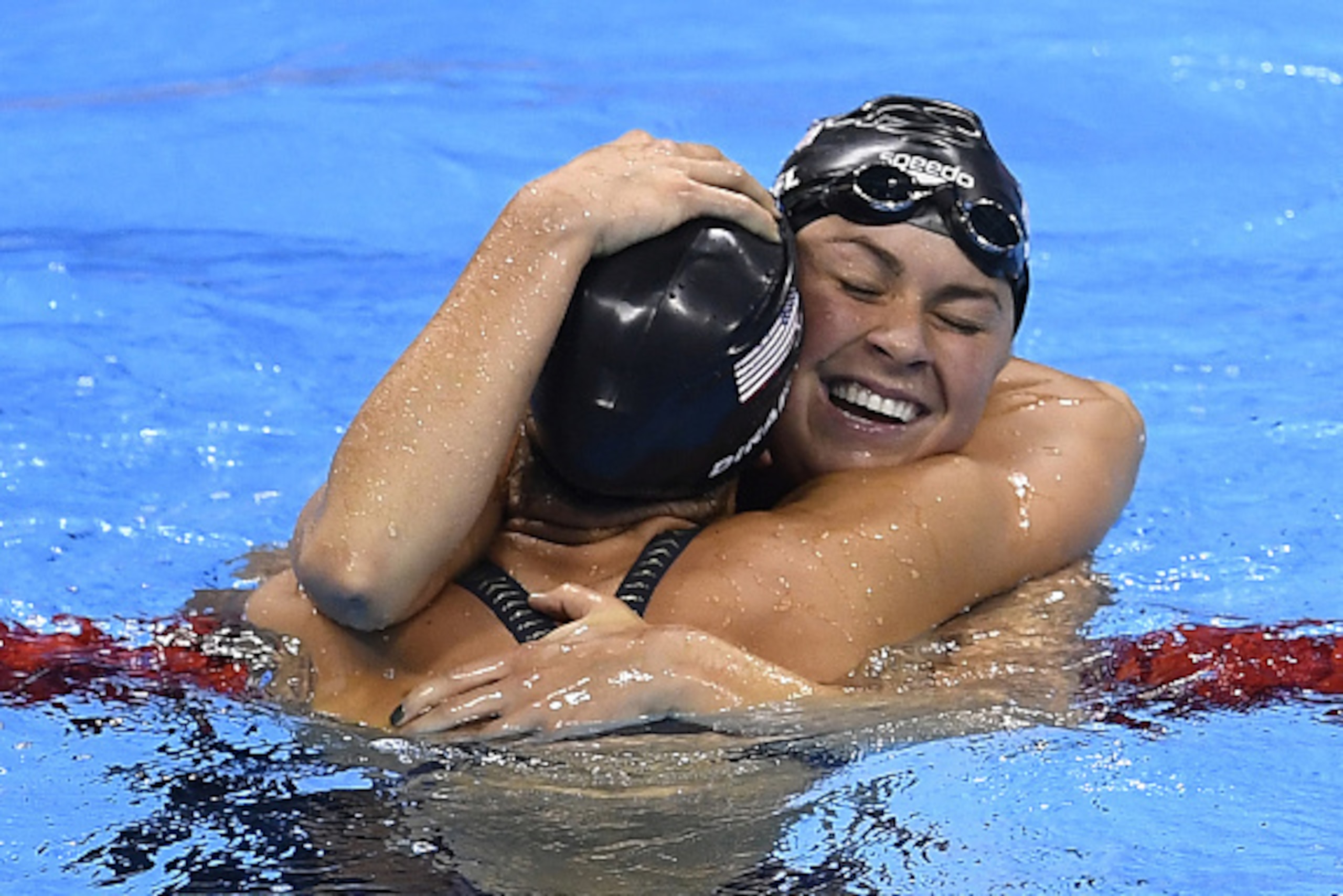 USA's Madeline 'Maya' Dirado (L) reacts to winning silver with USA's Elizabeth Beisel after the Women's 400m Individual Medley Final during the swimming event at the Rio 2016 Olympic Games at the Olympic Aquatics Stadium in Rio de Janeiro on August 6, 201