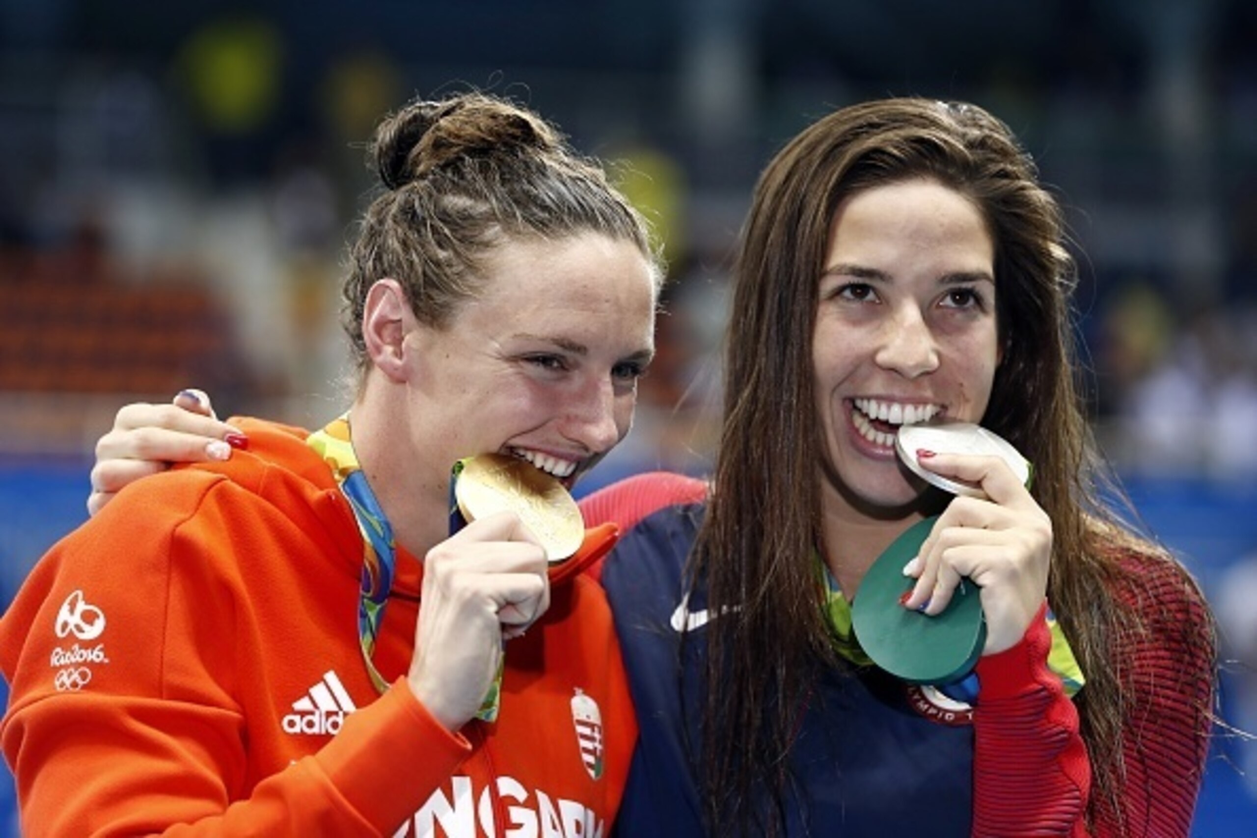 Hungary's Katinka Hosszu (L) and USA's Madeline 'Maya' Dirado pose on the podium after they respectively won gold and silver in the Women's 400m Individual Medley Final during the swimming event at the Rio 2016 Olympic Games at the Olympic Aquatics Stadiu