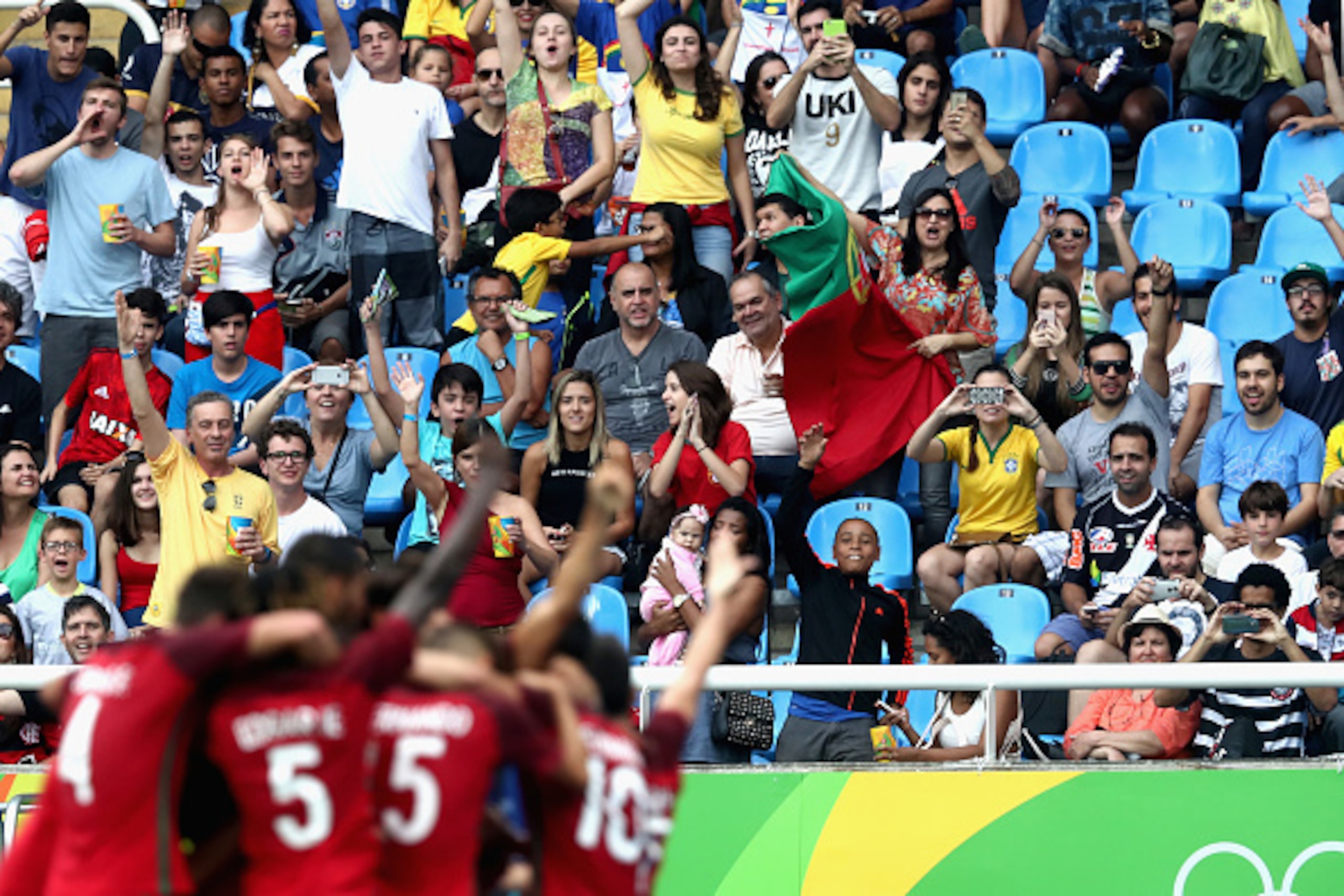 RIO DE JANEIRO, BRAZIL - AUGUST 07: Spectators celebrate Portugal's 2nd team goal during the Men's Group D first round match between Honduras and Portugal during the Rio 2016 Olympic Games at the Olympic Stadium on August 7, 2016 in Rio de Janeiro, Bra RIO DE JANEIRO, BRAZIL - AUGUST 07: Spectators celebrate Portugal's 2nd team goal during the Men's Group D first round match between Honduras and Portugal during the Rio 2016 Olympic Games at the Olympic Stadium on August 7, 2016 in Rio de Janeiro, Bra