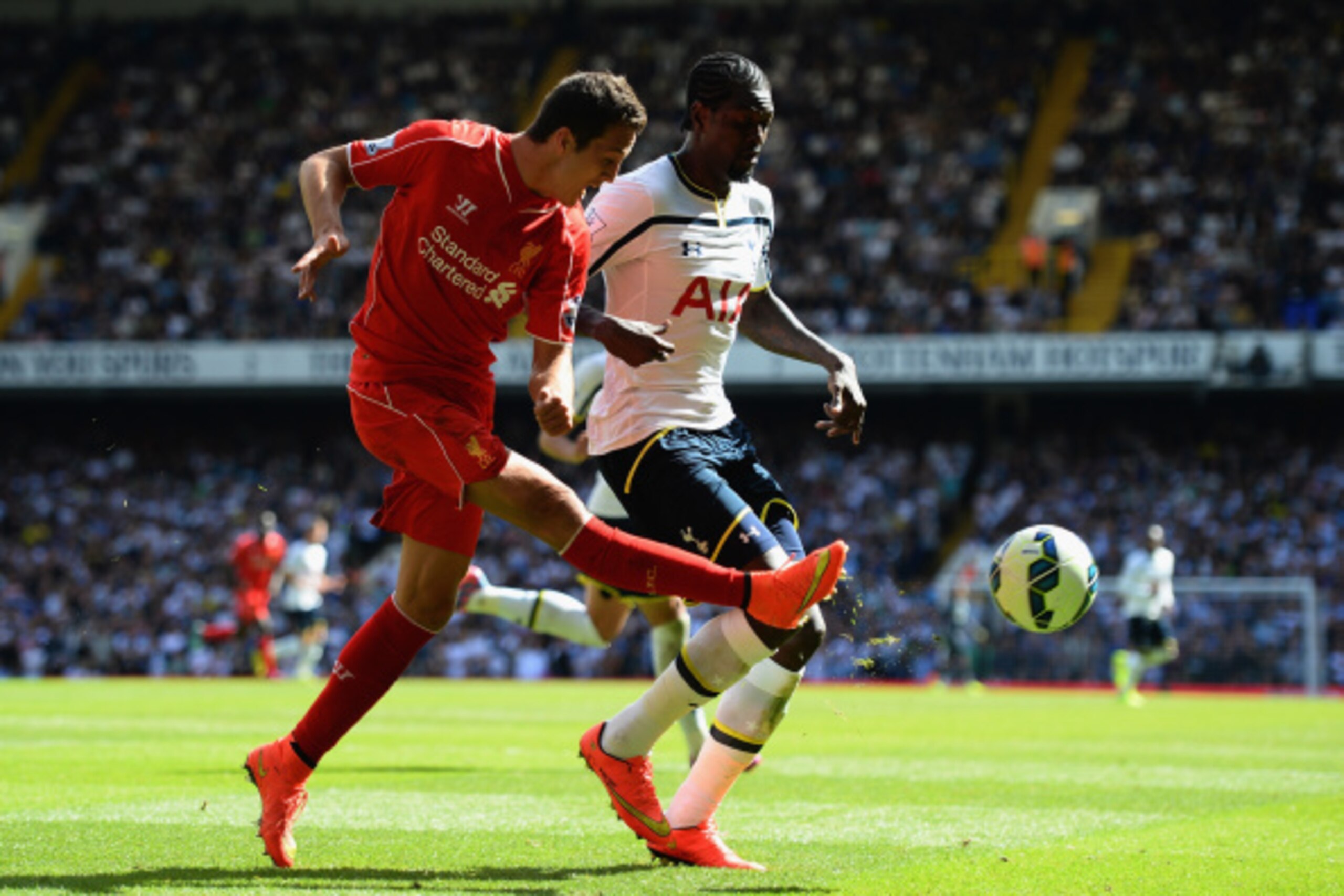 LONDON, ENGLAND - AUGUST 31:  Emmanuel Adebayour of Spurs and Javi Manquillo of Liverpool battle for the ba;; during the Barclays Premier League match between Tottenham Hotspur and Liverpool at White Hart Lane on August 31, 2014 in London, England.  (Phot