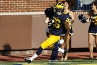 Oct 10, 2015; Ann Arbor, MI, USA; Michigan Wolverines cornerback Jourdan Lewis (26) scores a touchdown on an interception in the second quarter against the Northwestern Wildcats at Michigan Stadium. Mandatory Credit: Rick Osentoski-USA TODAY Sports