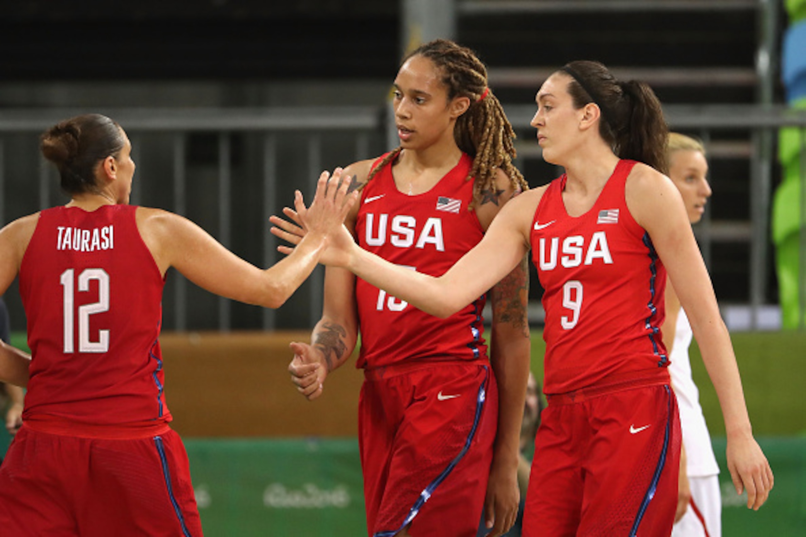 RIO DE JANEIRO, BRAZIL - AUGUST 08:  Breanna Stewart #9 and Brittney Griner #15 of United States high five Diana Taurasi #12 after scoring against Spain during the women's basketball game on Day 3 of the Rio 2016 Olympic Games at the Youth Arena on August