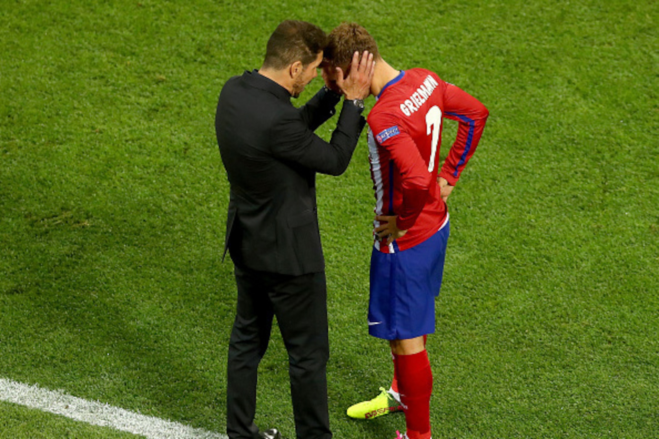 MILAN, ITALY - MAY 28: Antoine Griezmann of Atletico Madrid speaks to head coach Diego Simeone during the UEFA Champions League Final match between Real Madrid and Club Atletico de Madrid at Stadio Giuseppe Meazza on May 28, 2016 in Milan, Italy.  (Photo 