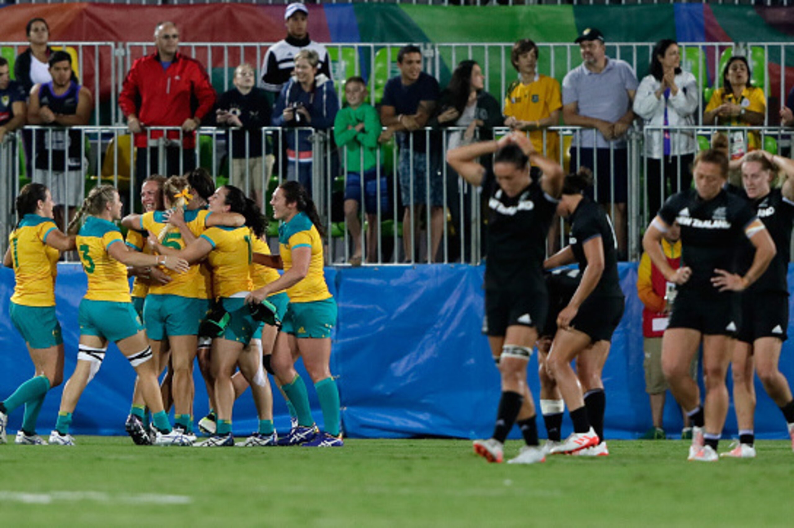 RIO DE JANEIRO, BRAZIL - AUGUST 08: Team Australia celebrates winning the Gold medal while team New Zealand look dejected after the Women's Gold Medal Rugby Sevens match between Australia and New Zealand on Day 3 of the Rio 2016 Olympic Games at the Deod RIO DE JANEIRO, BRAZIL - AUGUST 08: Team Australia celebrates winning the Gold medal while team New Zealand look dejected after the Women's Gold Medal Rugby Sevens match between Australia and New Zealand on Day 3 of the Rio 2016 Olympic Games at the Deod