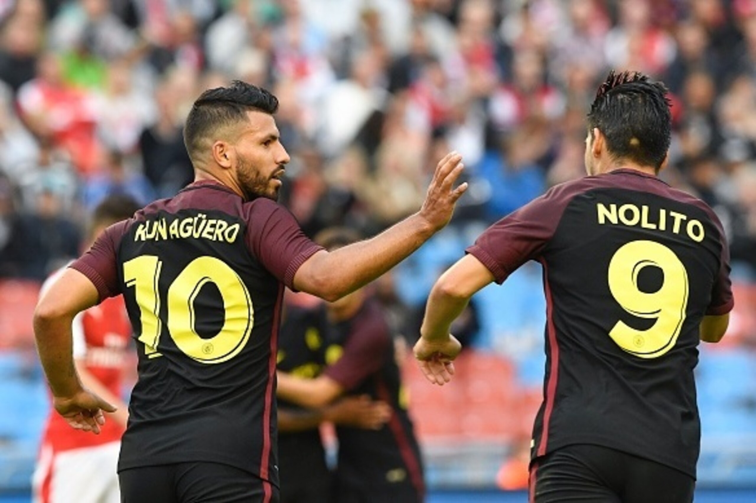 Manchester City's Argentinian forward Sergio Aguero (L) celebrates with his teammate Spanish forward Nolito after scoring during the friendly football match between Arsenal and Manchester City at the Ullevi stadium in Gothenburg on August 7, 2016. / AFP /