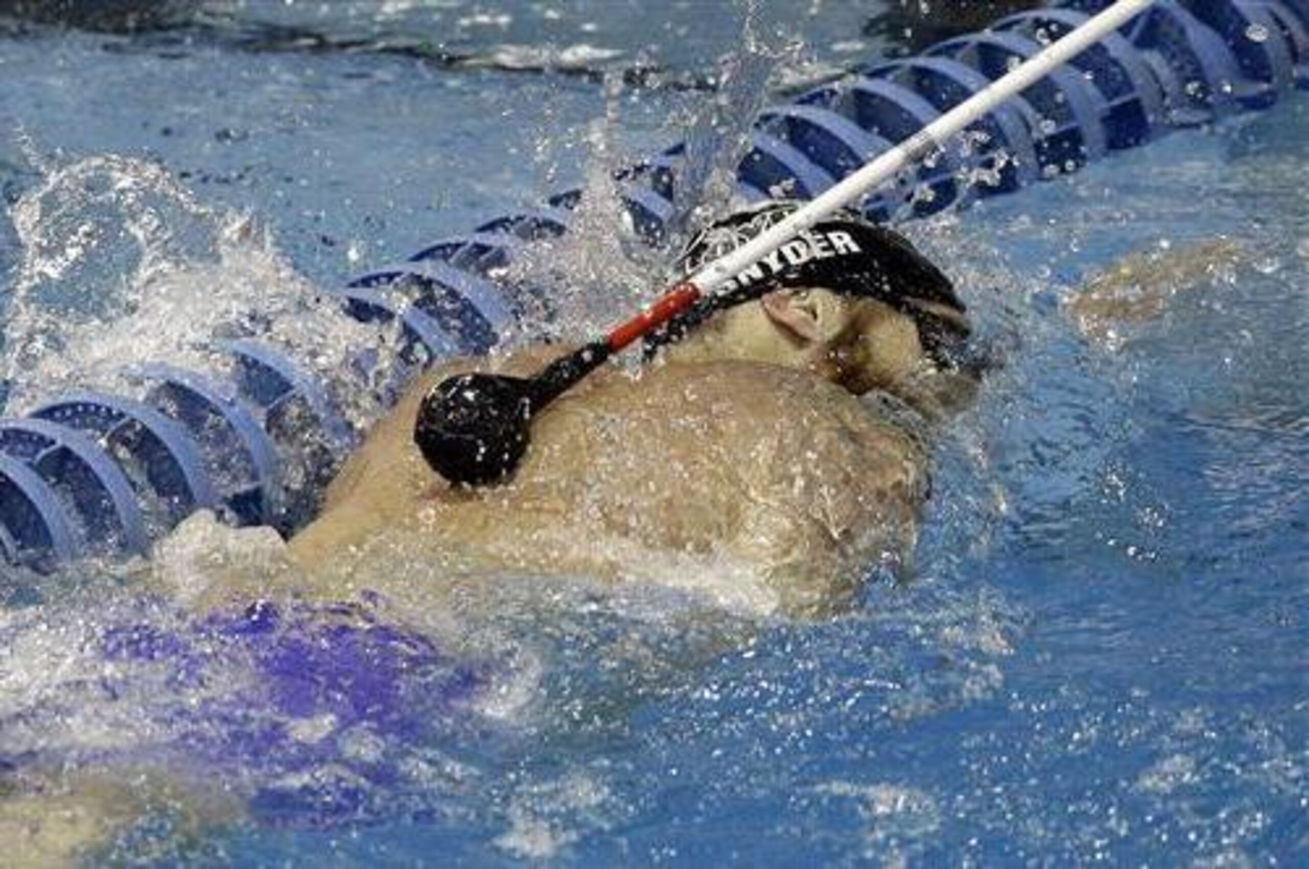 A tap on the back from a volunteer at pool's edge tells Paralympian swimmer Brad Snyder he's approaching a lane rope.