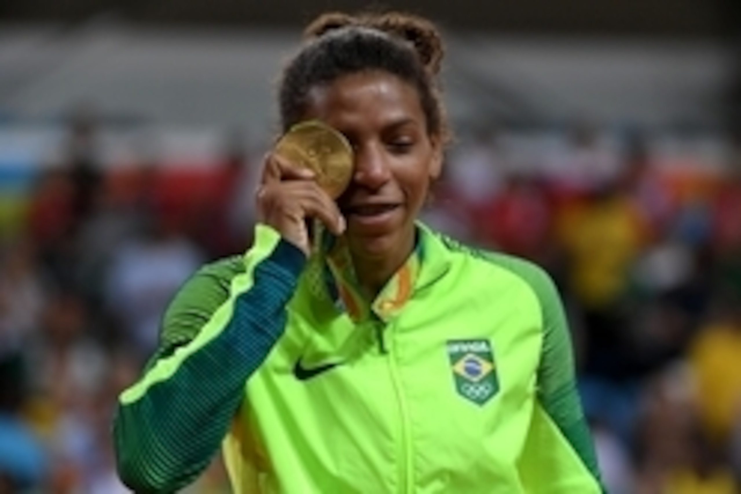 Aug 8, 2016; Rio de Janeiro, Brazil; Rafaela Silva (BRA) reacts during the women's 57-kg medal ceremony at Carioca Arena 2 during the Rio 2016 Summer Olympic Games. Mandatory Credit: Michael Madrid-USA TODAY Sports