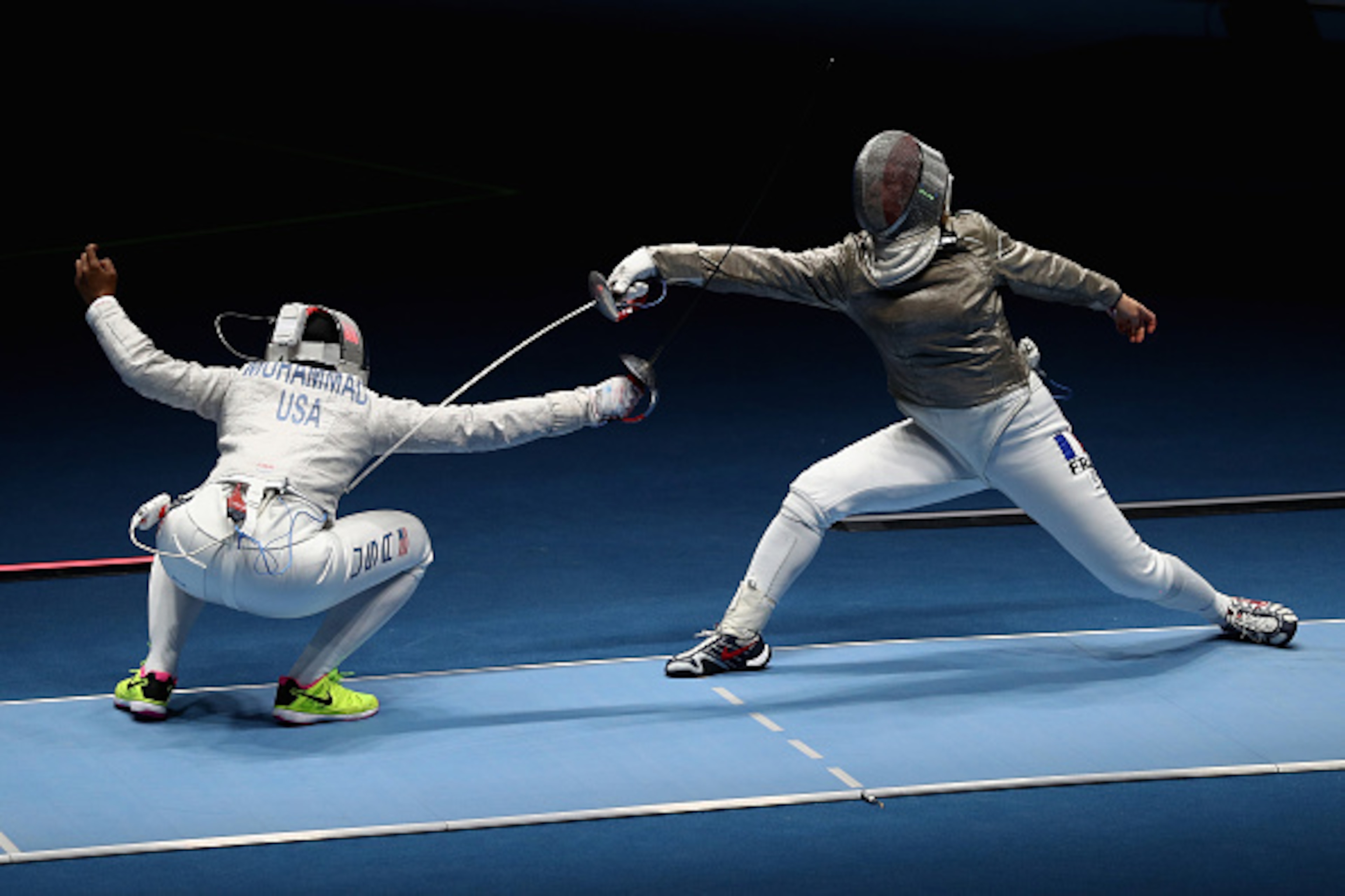 RIO DE JANEIRO, BRAZIL - AUGUST 08: Ibtihaj Muhammad of the United States (L) competes against Cecilia Berder of France during the Women's Individual Sabre on Day 3 of the Rio 2016 Olympic Games at Carioca Arena 3 on August 8, 2016 in Rio de Janeiro, Bra RIO DE JANEIRO, BRAZIL - AUGUST 08: Ibtihaj Muhammad of the United States (L) competes against Cecilia Berder of France during the Women's Individual Sabre on Day 3 of the Rio 2016 Olympic Games at Carioca Arena 3 on August 8, 2016 in Rio de Janeiro, Bra