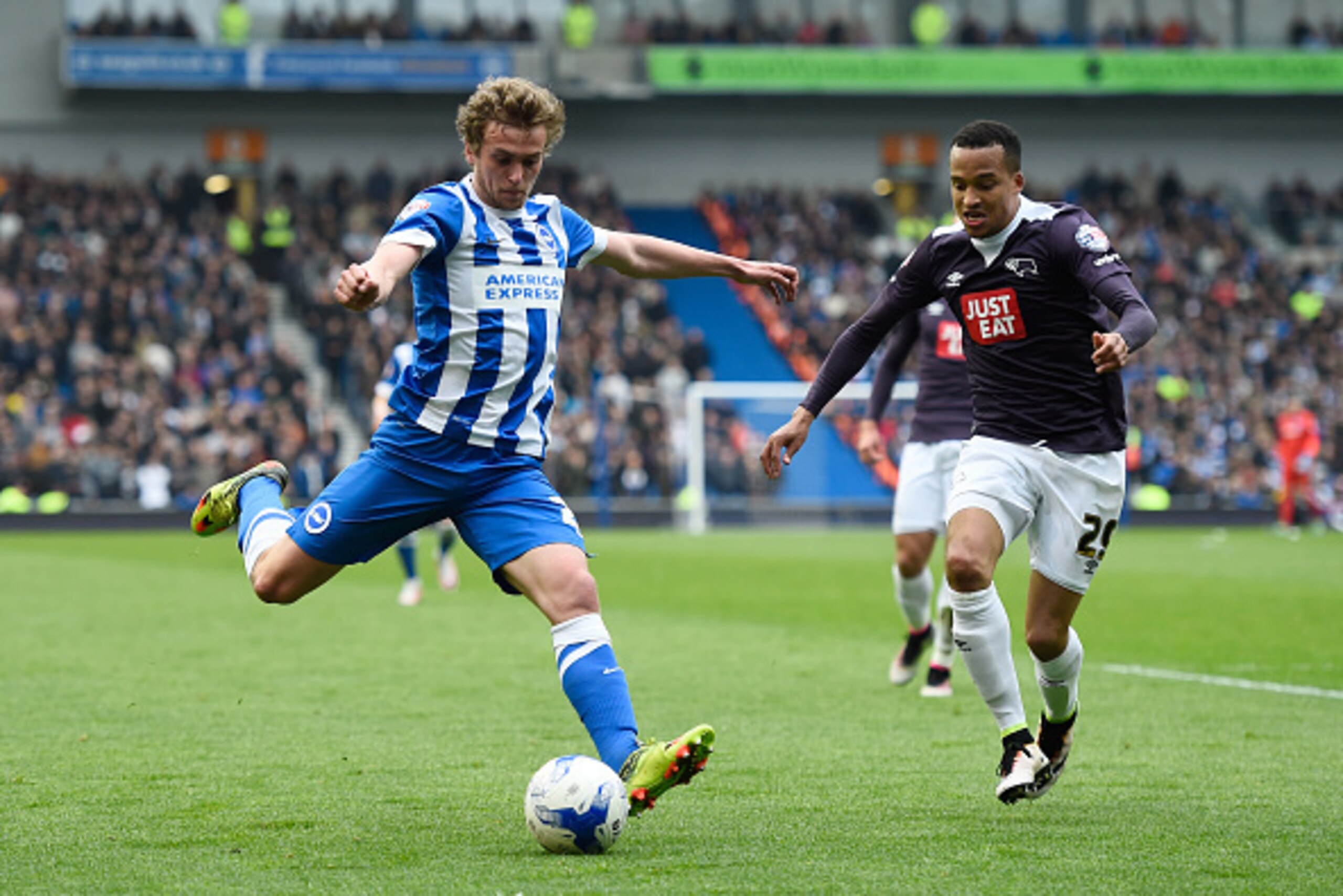 BRIGHTON, ENGLAND - MAY 02: James Wilson of Brighton and Hove Albion takes a shot on goal under pressure from Marcus Olsson of Derby County during the Sky Bet Championship match between Brighton and Hove Albion and Derby County at the Amex Stadium on May BRIGHTON, ENGLAND - MAY 02: James Wilson of Brighton and Hove Albion takes a shot on goal under pressure from Marcus Olsson of Derby County during the Sky Bet Championship match between Brighton and Hove Albion and Derby County at the Amex Stadium on May