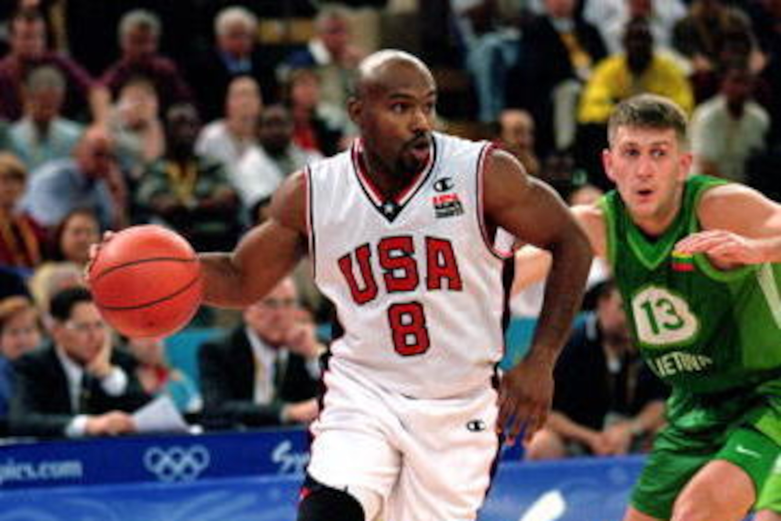 SYDNEY - SEPTEMBER 21: Tim Hardaway #8 of the USA drives the ball around his defender during the men's preliminary game against Lithuania at the Sydney SuperDome during the Sydney Olympic Games in Sydney, Australia on September 21, 2000. The USA defeate SYDNEY - SEPTEMBER 21: Tim Hardaway #8 of the USA drives the ball around his defender during the men's preliminary game against Lithuania at the Sydney SuperDome during the Sydney Olympic Games in Sydney, Australia on September 21, 2000. The USA defeate