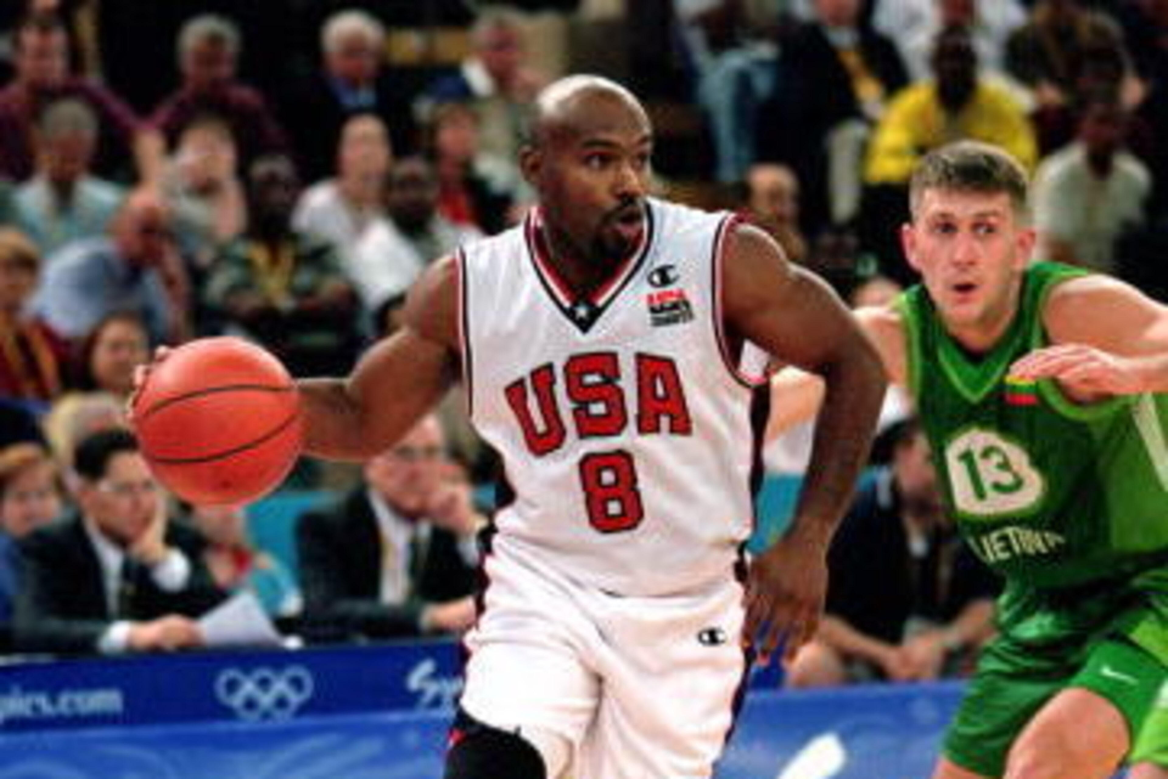 SYDNEY - SEPTEMBER 21:  Tim Hardaway #8 of the USA drives the ball around his defender during the men's preliminary game against Lithuania at the Sydney SuperDome during the Sydney Olympic Games in Sydney, Australia on September 21, 2000.  The USA defeate