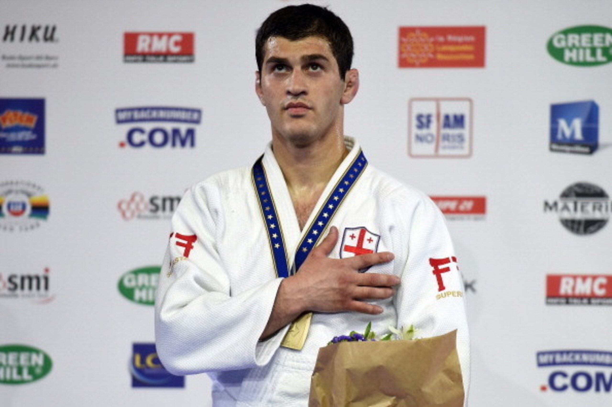 Georgia's Avtandil Tchrikishvili celebrates on the podium after the final of the Judo European Championships in the men's below 70kg category, in Montpellier, southern France, on April 25, 2014. Tchrikishvili won the contest and is the new European Judo C