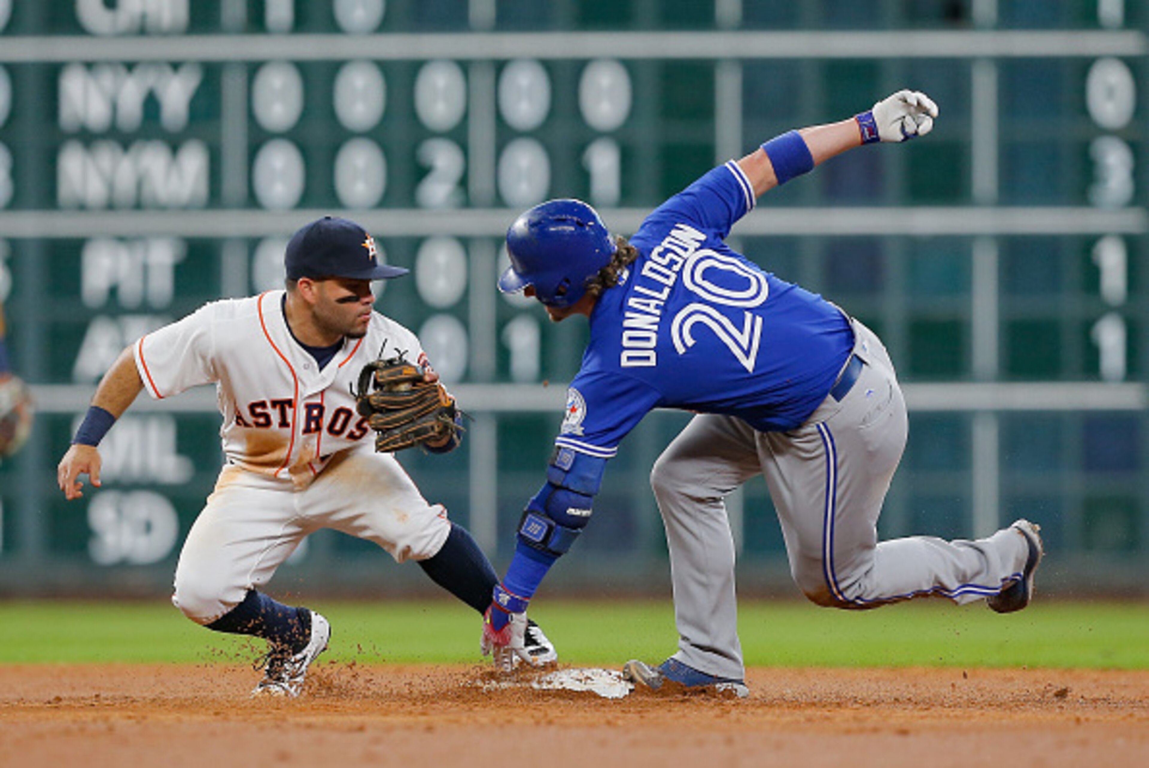 HOUSTON, TX - AUGUST 02:  Josh Donaldson #20 of the Toronto Blue Jays is tagged out by Jose Altuve #27 of the Houston Astros trying to stretch a single in the third inning at Minute Maid Park on August 2, 2016 in Houston, Texas.  (Photo by Bob Levey/Getty