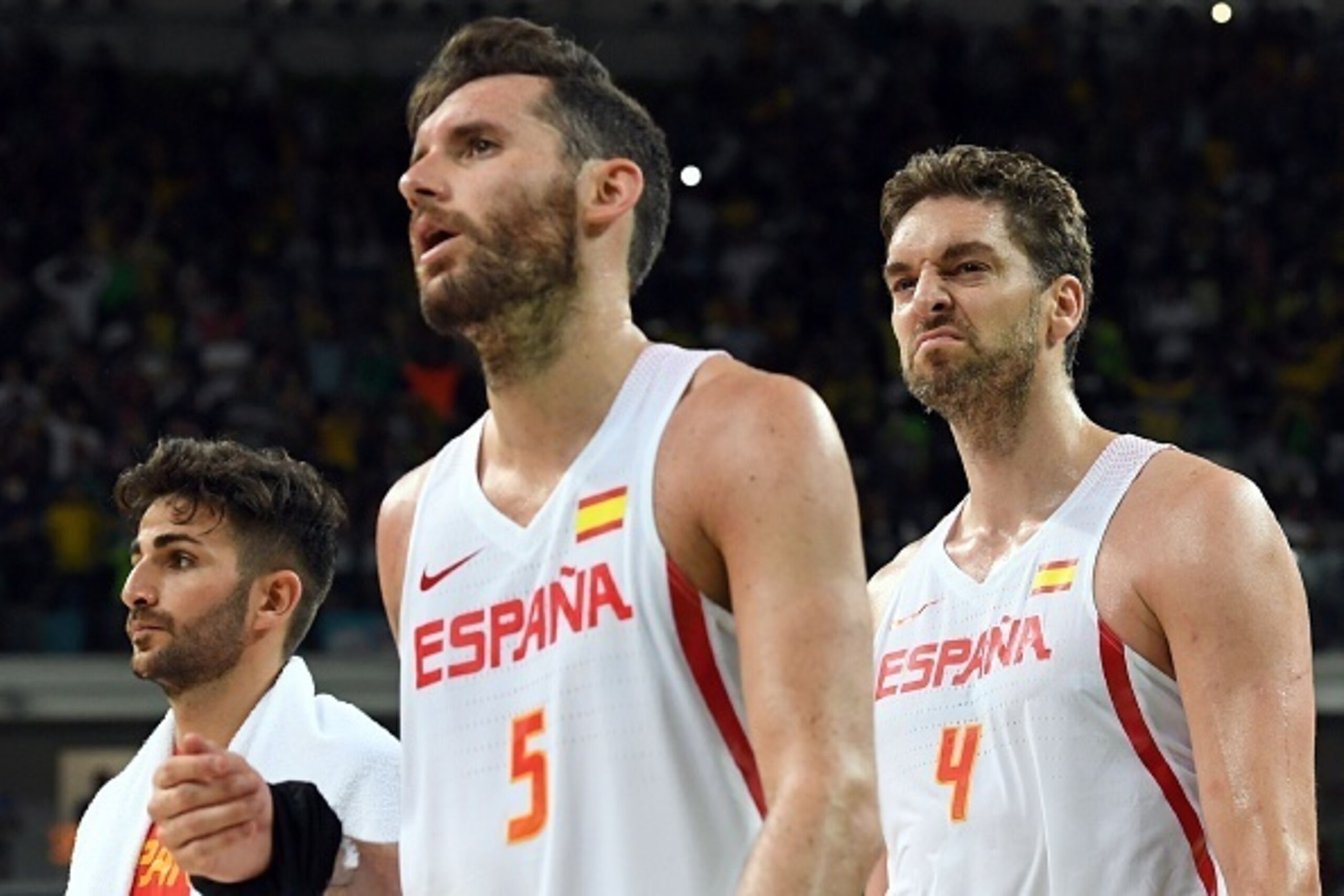 Spain's centre Pau Gasol (R), Spain's small forward Rudy Fernandez (C) and Spain's point guard Ricky Rubio leave the court after Brazil defeated Spain during a Men's round Group B basketball match between Spain and Brazil at the Carioca Arena 1 in Rio de 