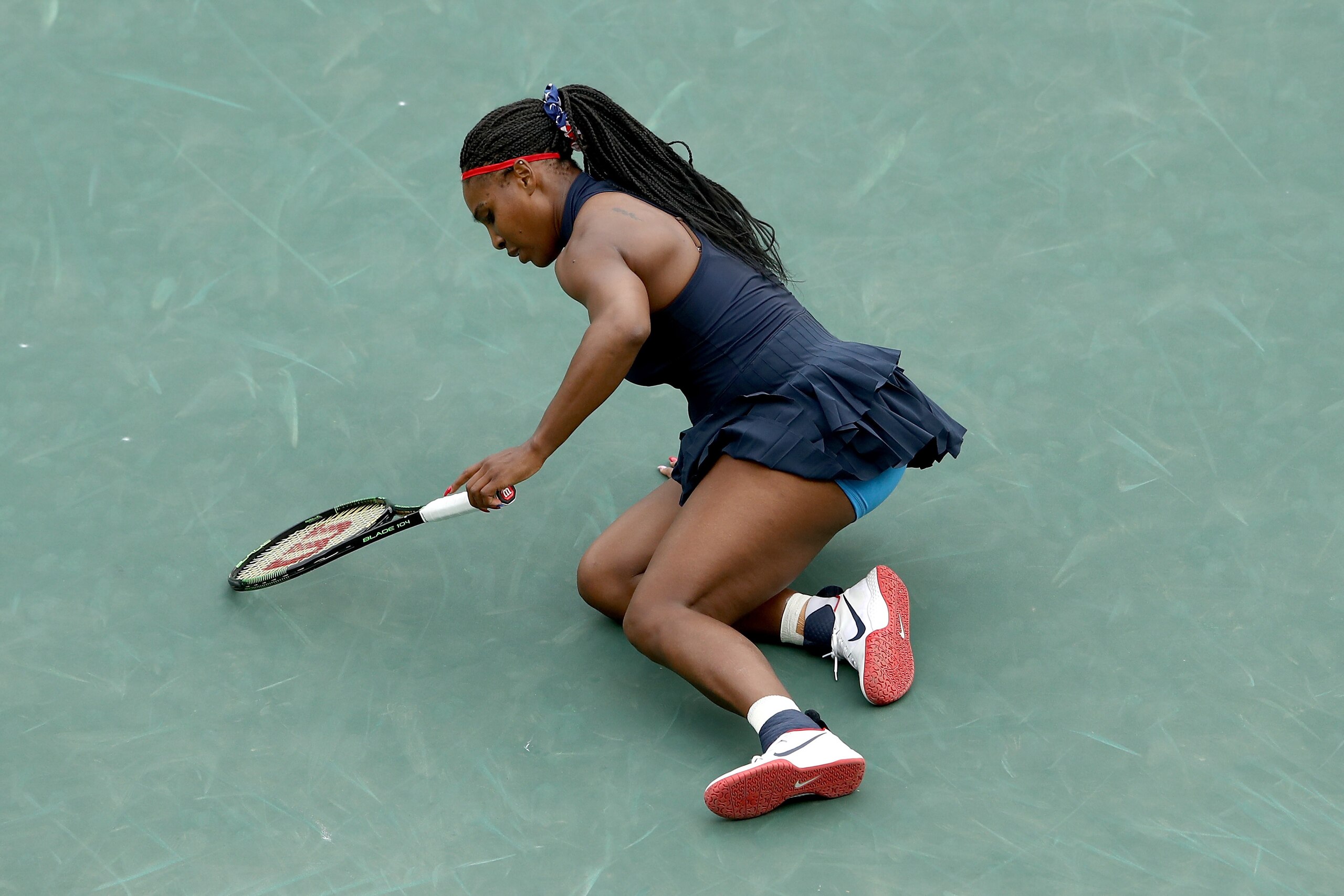 RIO DE JANEIRO, BRAZIL - AUGUST 07:  Serena Williams of the United States stumbles during her match with Daria Gavrilova of Australia in their first round match on Day 2 of the Rio 2016 Olympic Games at the Olympic Tennis Centre on August 7, 2016 in Rio d