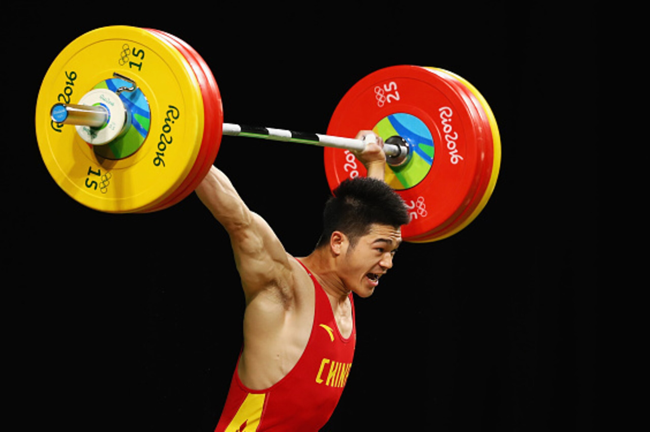RIO DE JANEIRO, BRAZIL - AUGUST 09: Zhiyong Shi of China competes during the Men's 69kg Group A Weightlifting contest on Day 4 of the Rio 2016 Olympic Games at the Riocentro - Pavilion 2 on August 9, 2016 in Rio de Janeiro, Brazil. (Photo by Dean Mouhta RIO DE JANEIRO, BRAZIL - AUGUST 09: Zhiyong Shi of China competes during the Men's 69kg Group A Weightlifting contest on Day 4 of the Rio 2016 Olympic Games at the Riocentro - Pavilion 2 on August 9, 2016 in Rio de Janeiro, Brazil. (Photo by Dean Mouhta