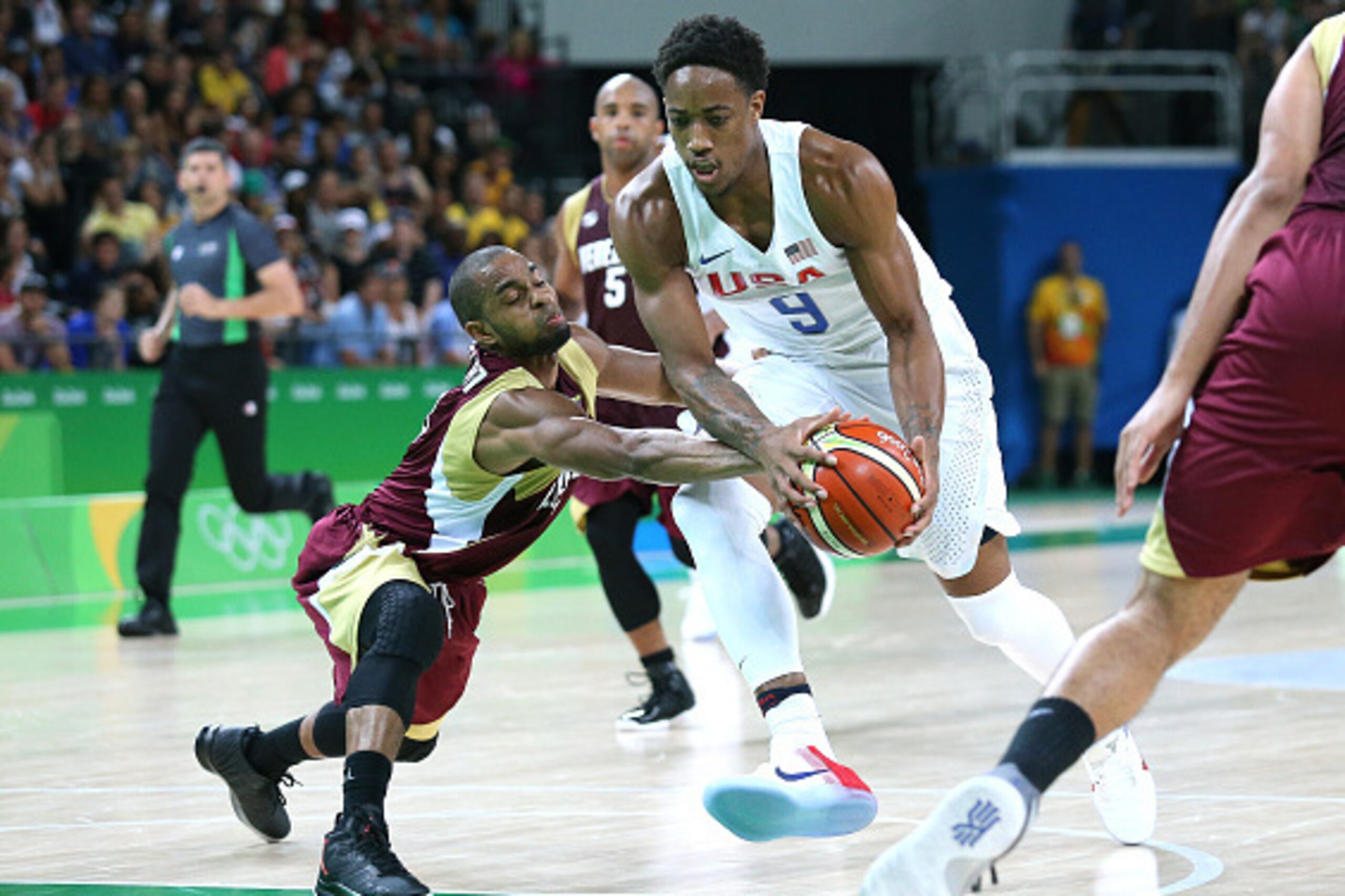RIO DE JANEIRO, BRAZIL - AUGUST 8: DeMar DeRozan of USA and David Cubillan of Venezuela (left) in action during the men's basketball match between USA and Venezuela at Arena Carioca 1 on day 3 of the Rio 2016 Olympic Games on August 8, 2016 in Rio de Jane RIO DE JANEIRO, BRAZIL - AUGUST 8: DeMar DeRozan of USA and David Cubillan of Venezuela (left) in action during the men's basketball match between USA and Venezuela at Arena Carioca 1 on day 3 of the Rio 2016 Olympic Games on August 8, 2016 in Rio de Jane
