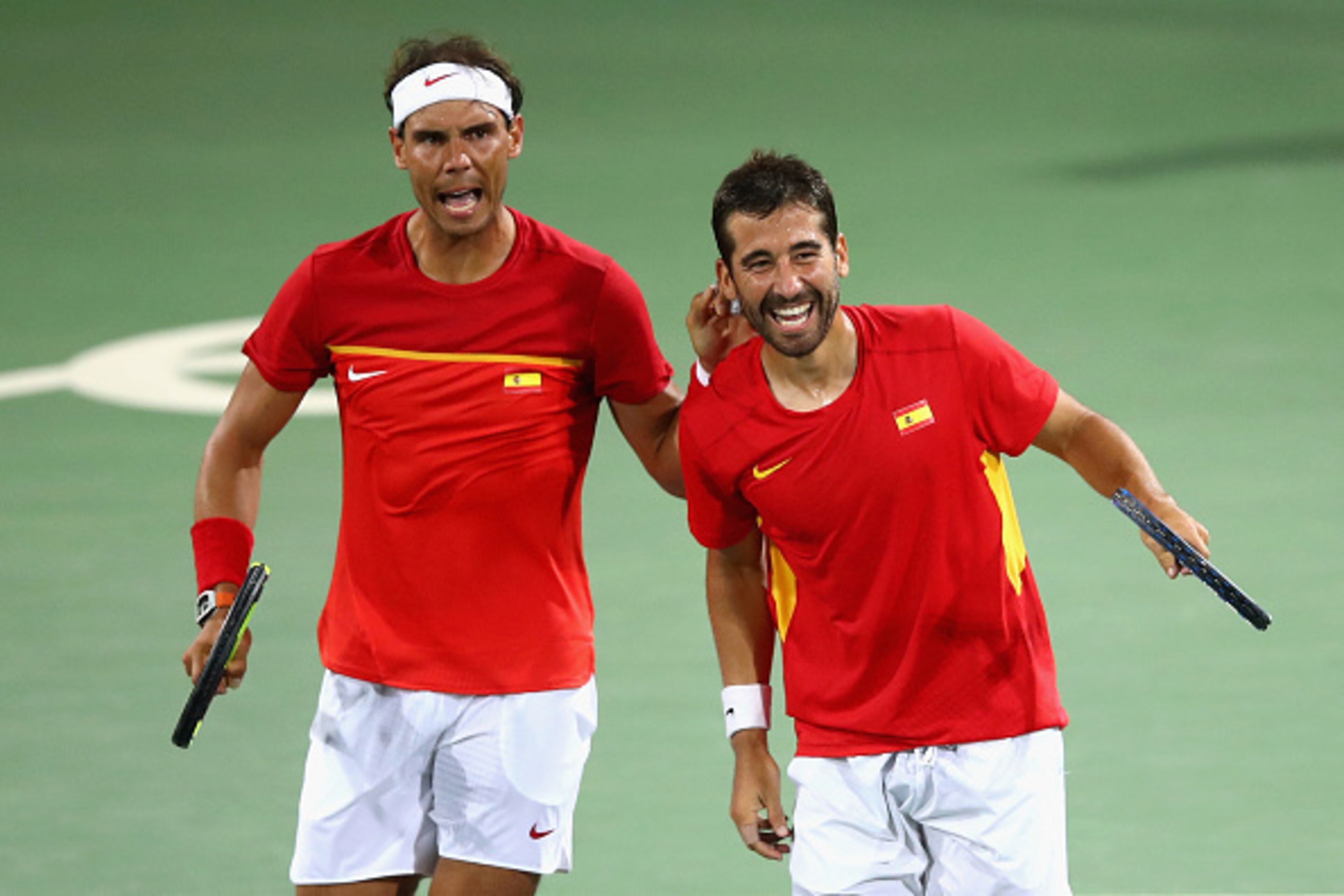 RIO DE JANEIRO, BRAZIL - AUGUST 09:  Rafael Nadal (L) and Marc Lopez of Spain celebrate defeating Oliver Marach and Alexander Peya of Austria in a Men's Doubles Quarterfinals match on Day 4 of the Rio 2016 Olympic Games at the Olympic Tennis Centre on Aug