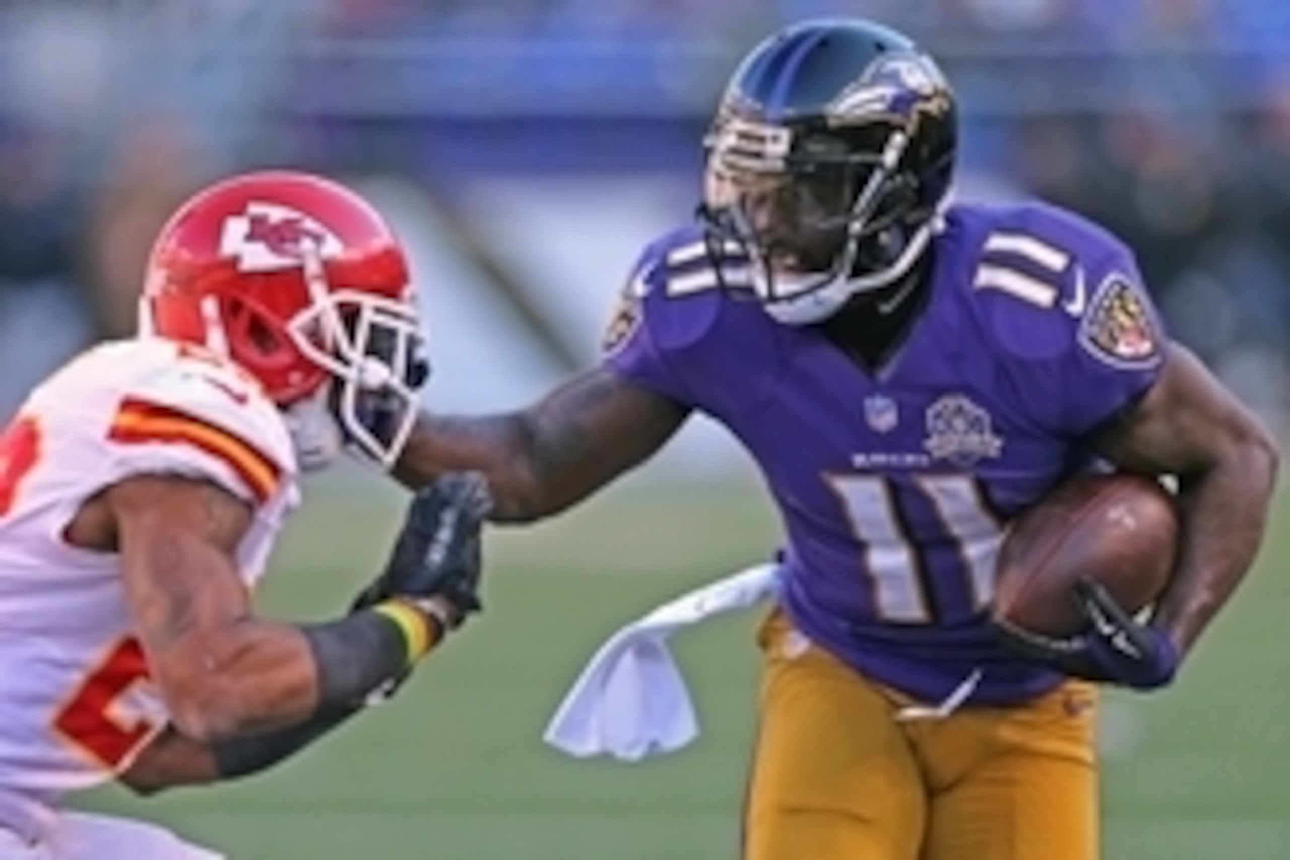 Dec 20, 2015; Baltimore, MD, USA; Baltimore Ravens wide receiver Kamar Aiken (11) stiff arms Kansas City Chiefs cornerback Marcus Peters (22) after his catch at M&T Bank Stadium. Mandatory Credit: Mitch Stringer-USA TODAY Sports