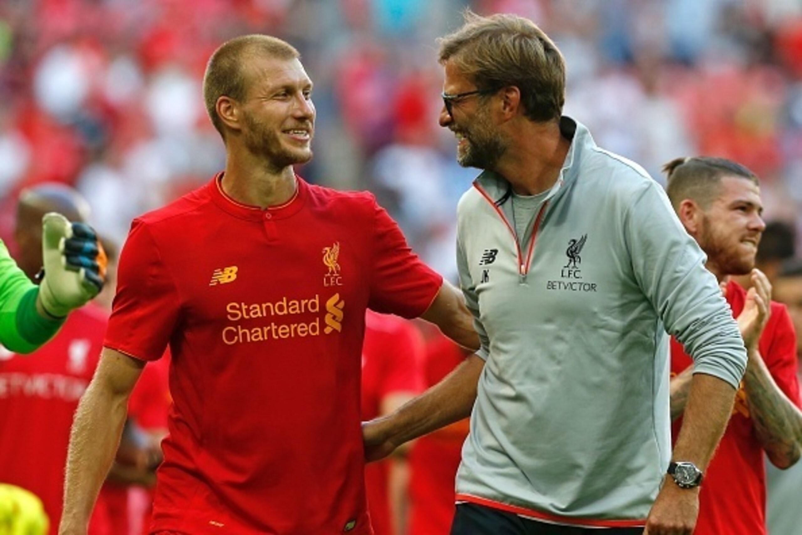 Liverpool's German manager Jurgen Klopp (R) and Liverpool's Estonian defender Ragnar Klavan celebrate on the pitch after the pre-season International Champions Cup football match between Spanish champions, Barcelona and Liverpool at Wembley stadium in Lon