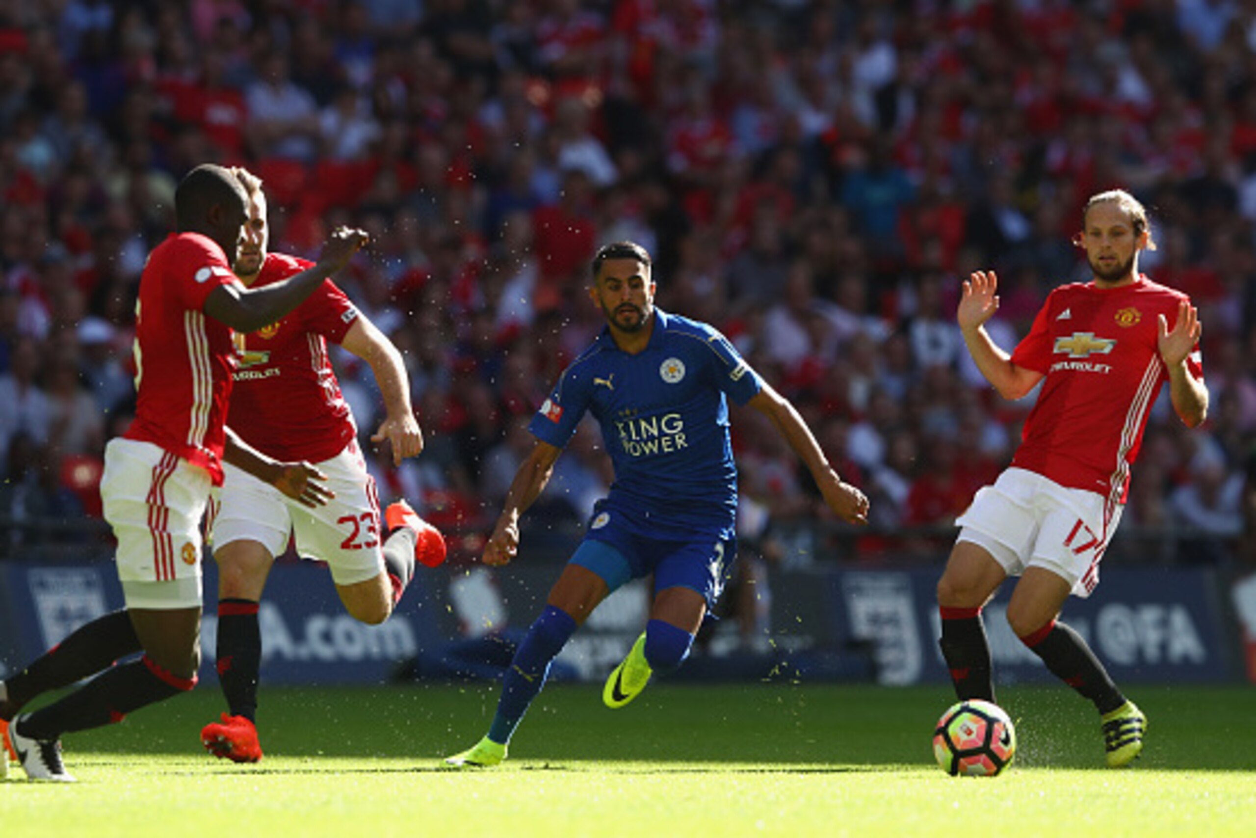 LONDON, ENGLAND - AUGUST 07:  Riyad Mahrez of Leicester City cuts between Eric Bailly (L), Luke Shaw (2L) and Daley Blind (R) of Manchester United during the Community Shield match between Leicester City and Manchester United at Wembley Stadium on August 
