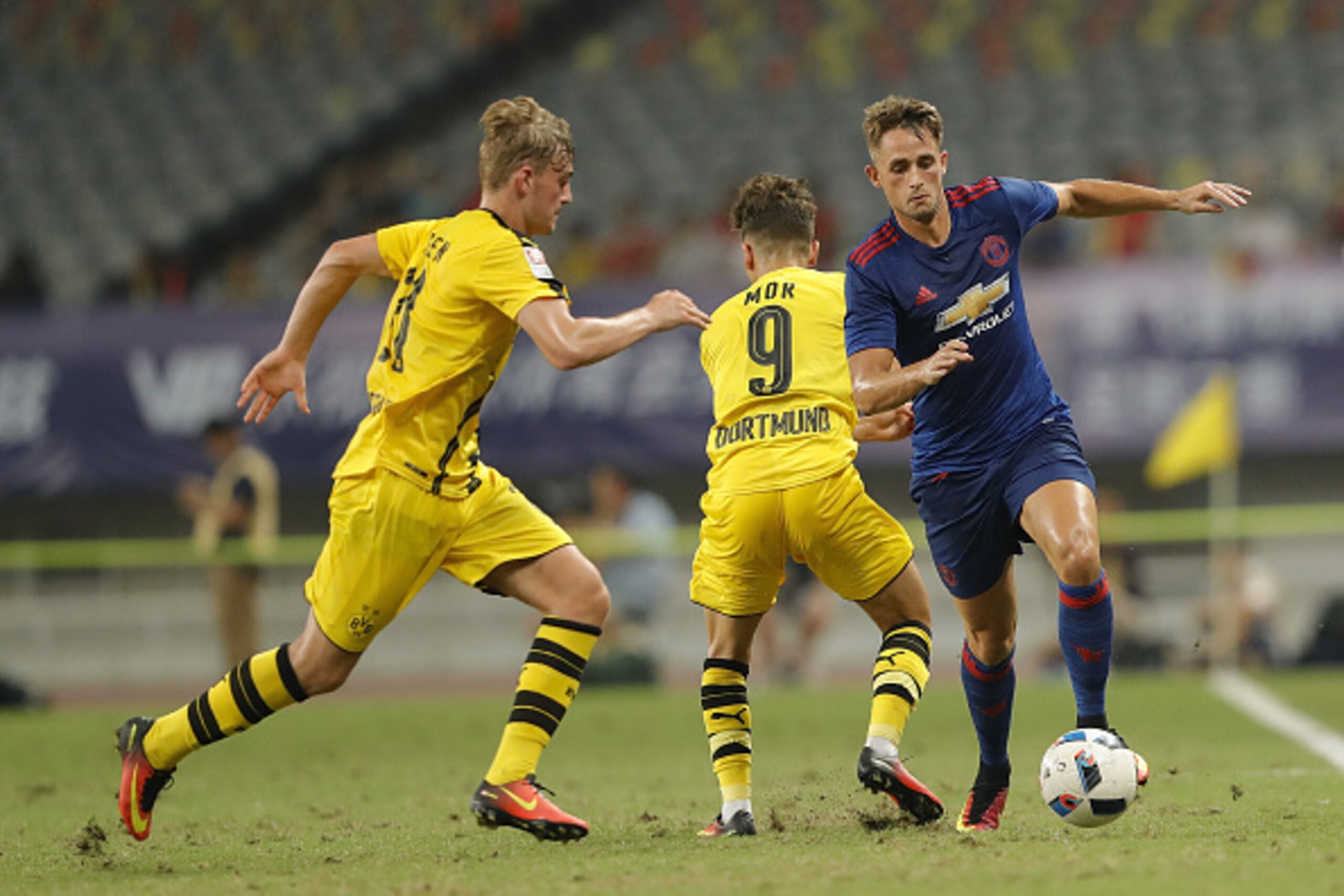 SHANGHAI, CHINA - JULY 22:  Adnan Januzaj (R) of Manchester United competes for the ball with Jacob Bruun Larsen of Borussia Dortmund during the International Champions Cup match between Manchester United and Borussia Dortmund at Shanghai Stadium on July 