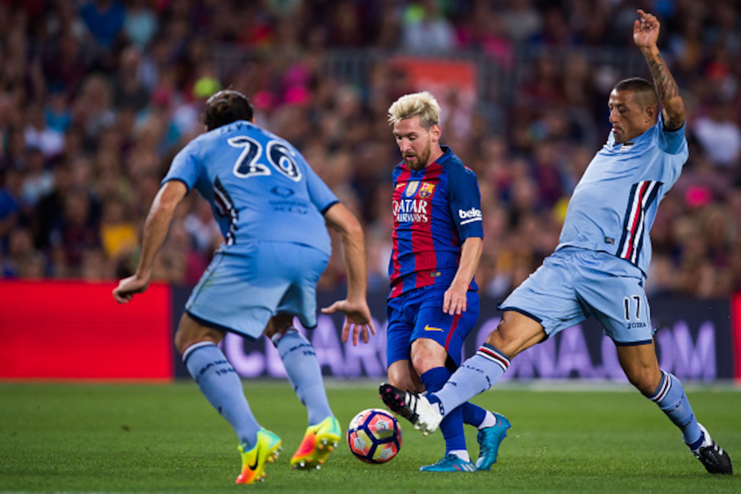 BARCELONA, SPAIN - AUGUST 10: Lionel Messi (C) of FC Barcelona conducts the ball between Matias Agustin Silvestre (L) and Angelo Palombo (R) of UC Sampdoria during the Joan Gamper trophy match between FC Barcelona and UC Sampdoria at Camp Nou on August 10