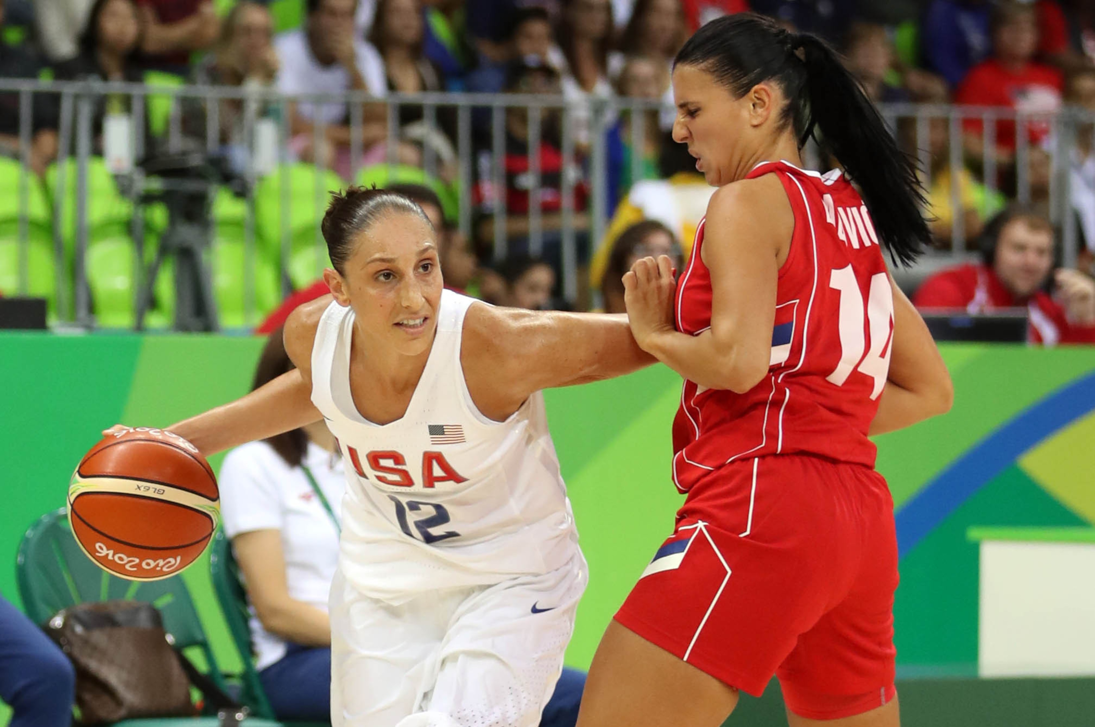 Aug 10, 2016; Rio de Janeiro, Brazil; USA guard Diana Taurasi (12) drives to the basket against Serbia guard/forward Ana Dabovic (14) during the women's basketball preliminary round in the Rio 2016 Summer Olympic Games at Youth Arena. Mandatory Credit: Ja