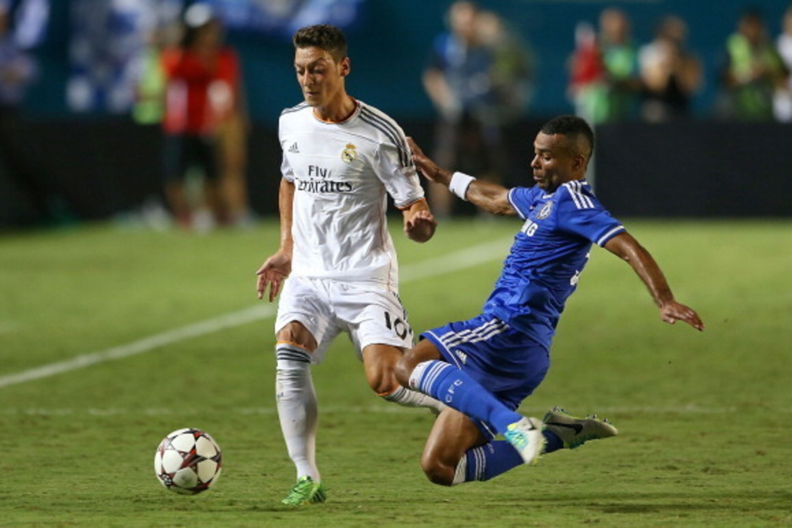 MIAMI GARDENS, FL - AUGUST 07:  Mesut Ozil #10 of Real Madrid and Ashley Cole #3 of Chelsea fight for a ball during International Champions Cup  Championship match  at Sun Life Stadium on August 7, 2013 in Miami Gardens, Florida.  (Photo by Mike Ehrmann/G
