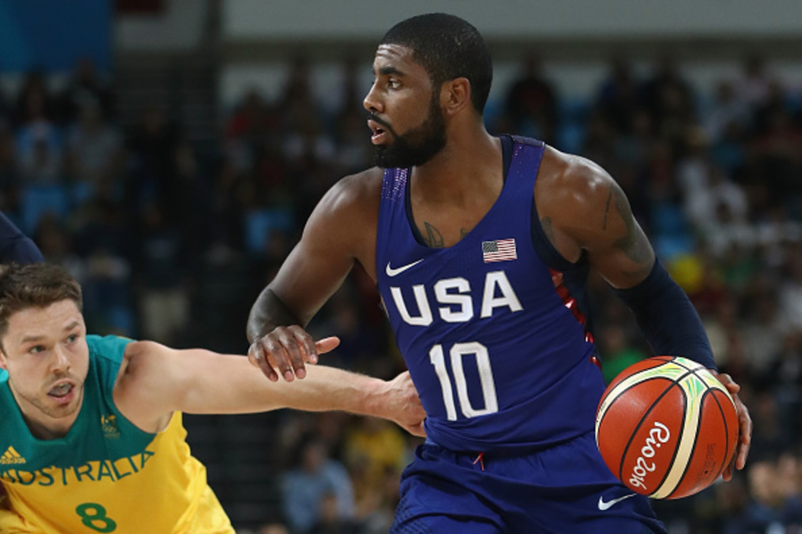 RIO DE JANEIRO, BRAZIL - AUGUST 10: Kyrie Irving #10 of United States handles the ball against Matthew Dellavedova #8 of Australia during the Men's Preliminary Round Group A between Australia and the United States on Day 5 of the Rio 2016 Olympic Games at