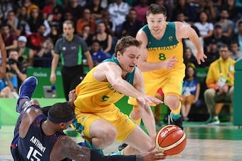 USA's forward Carmelo Anthony (L) and Australia's forward Ryan Broekhoff fall for the ball during a Men's round Group A basketball match between Australia and USA at the Carioca Arena 1 in Rio de Janeiro on August 10, 2016 during the Rio 2016 Olympic Game
