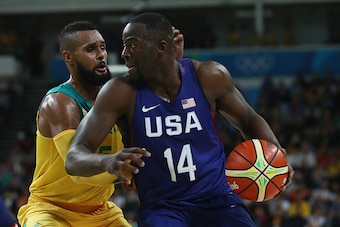 RIO DE JANEIRO, BRAZIL - AUGUST 10:  Draymond Green #14 of United States handles the ball against Patty Mills #5 of Australia during the Men's Preliminary Round Group A between Australia and the United States on Day 5 of the Rio 2016 Olympic Games at Cari