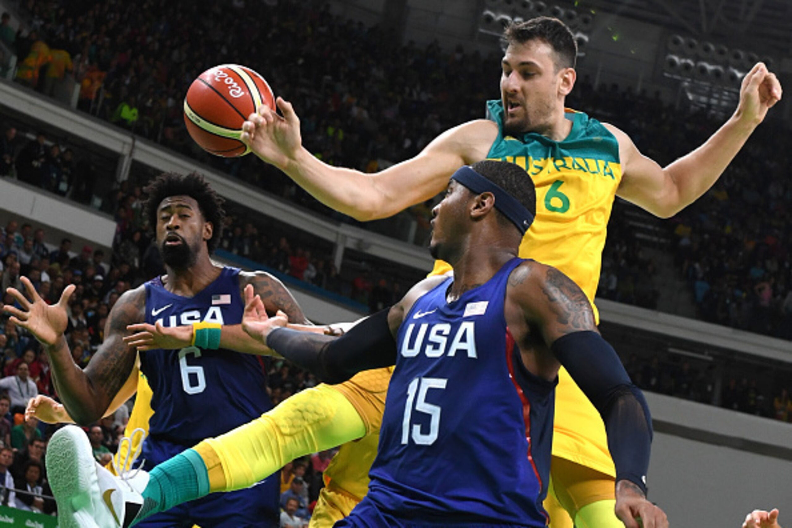 USA's centre DeAndre Jordan (L) and USA's forward Carmelo Anthony (C) reach for the ball with Australia's centre Andrew Bogut during a Men's round Group A basketball match between Australia and USA at the Carioca Arena 1 in Rio de Janeiro on August 10, 20