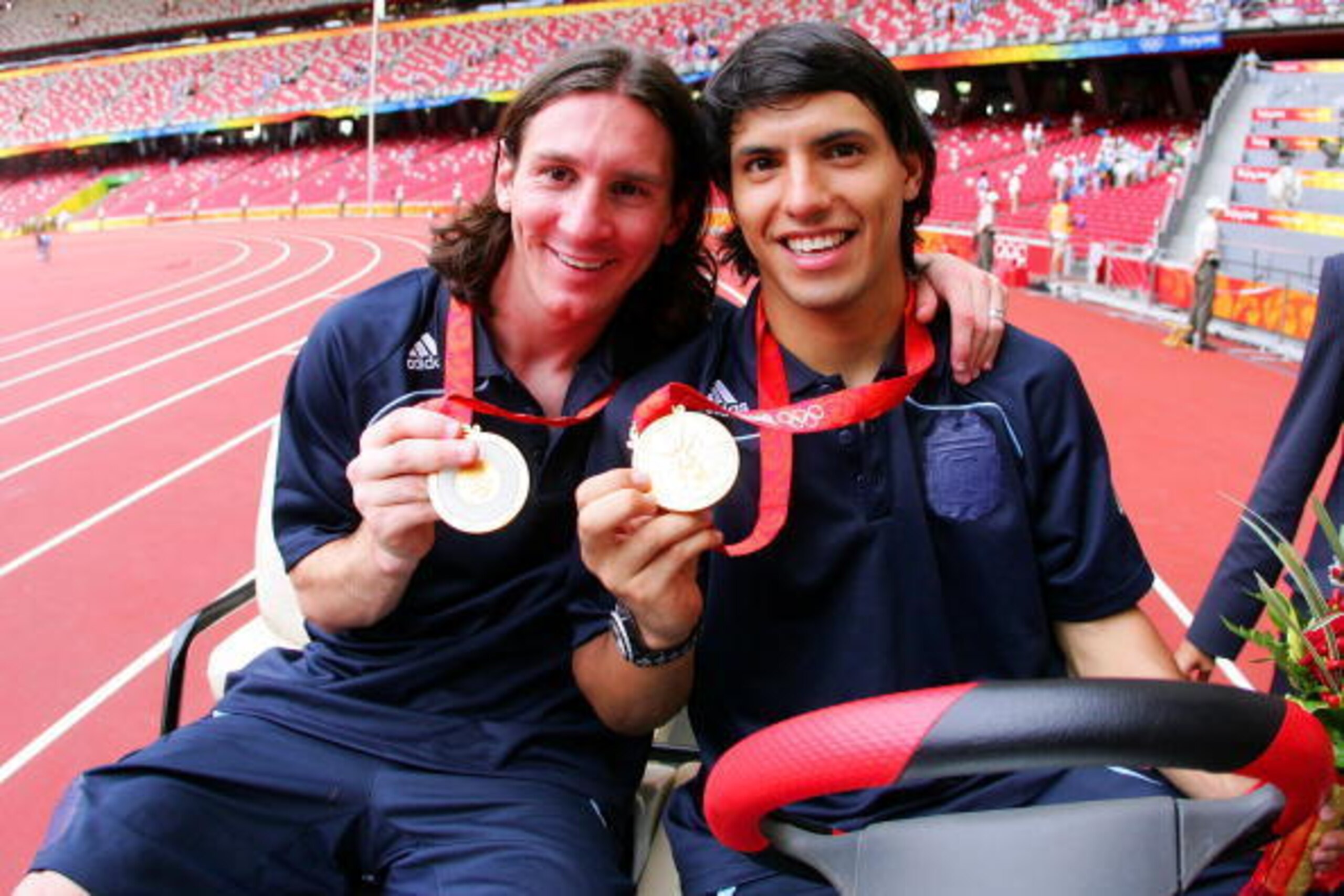 BEIJING - AUGUST 23: Argentinian forwards Lionel Messi (L) and Sergio Aguero  gold medal pose during the men's Olympic football tournament medal ceremony at the national stadium in Beijing during  the Men's Final between Nigeria and Argentina at the Natio