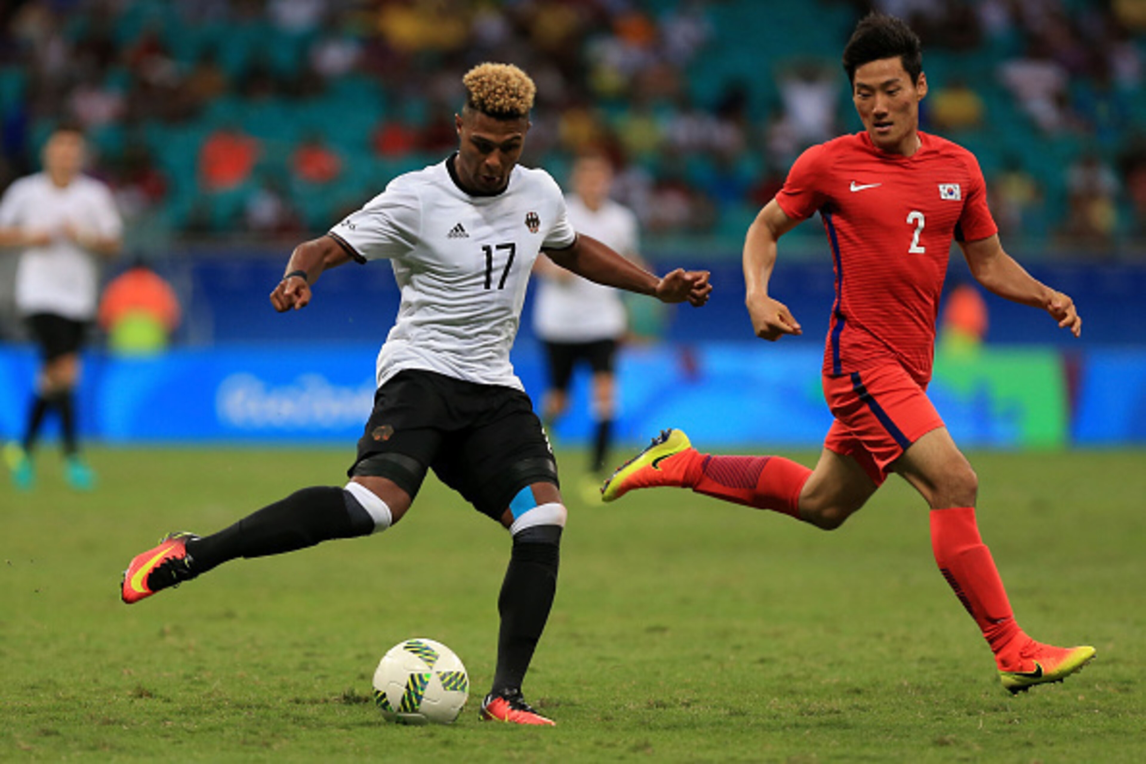 SALVADOR, BRAZIL - AUGUST 07:  Serge Gnabry of Germany runs with the ball against Sangmin Sim of Korea during the Men's First Round Group C match between Germany and Korea at Arena Fonte Nova on August 7, 2016 in Salvador, Brazil.  (Photo by Felipe Olivei