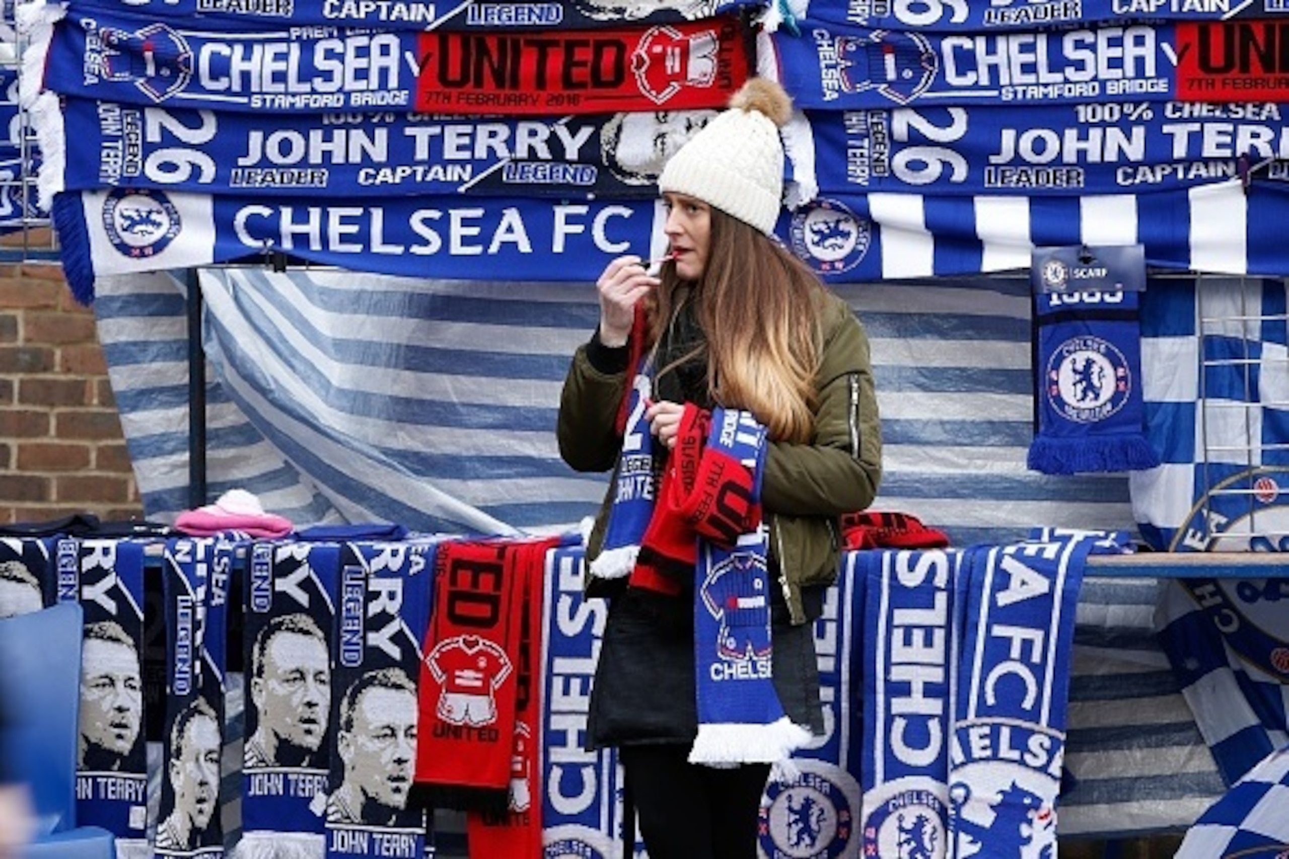 Football scarves on sale before the English Premier League football match between Chelsea and Manchester United at Stamford Bridge in London on on February 7, 2016. / AFP / ADRIAN DENNIS / RESTRICTED TO EDITORIAL USE. No use with unauthorized audio, video