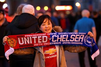 MANCHESTER, ENGLAND - DECEMBER 28:  A Manchester United fan poses with a scarf outside the stadium before the Barclays Premier League match between Manchester United and Chelsea at Old Trafford on December 28, 2015 in Manchester, England.  (Photo by Alex 