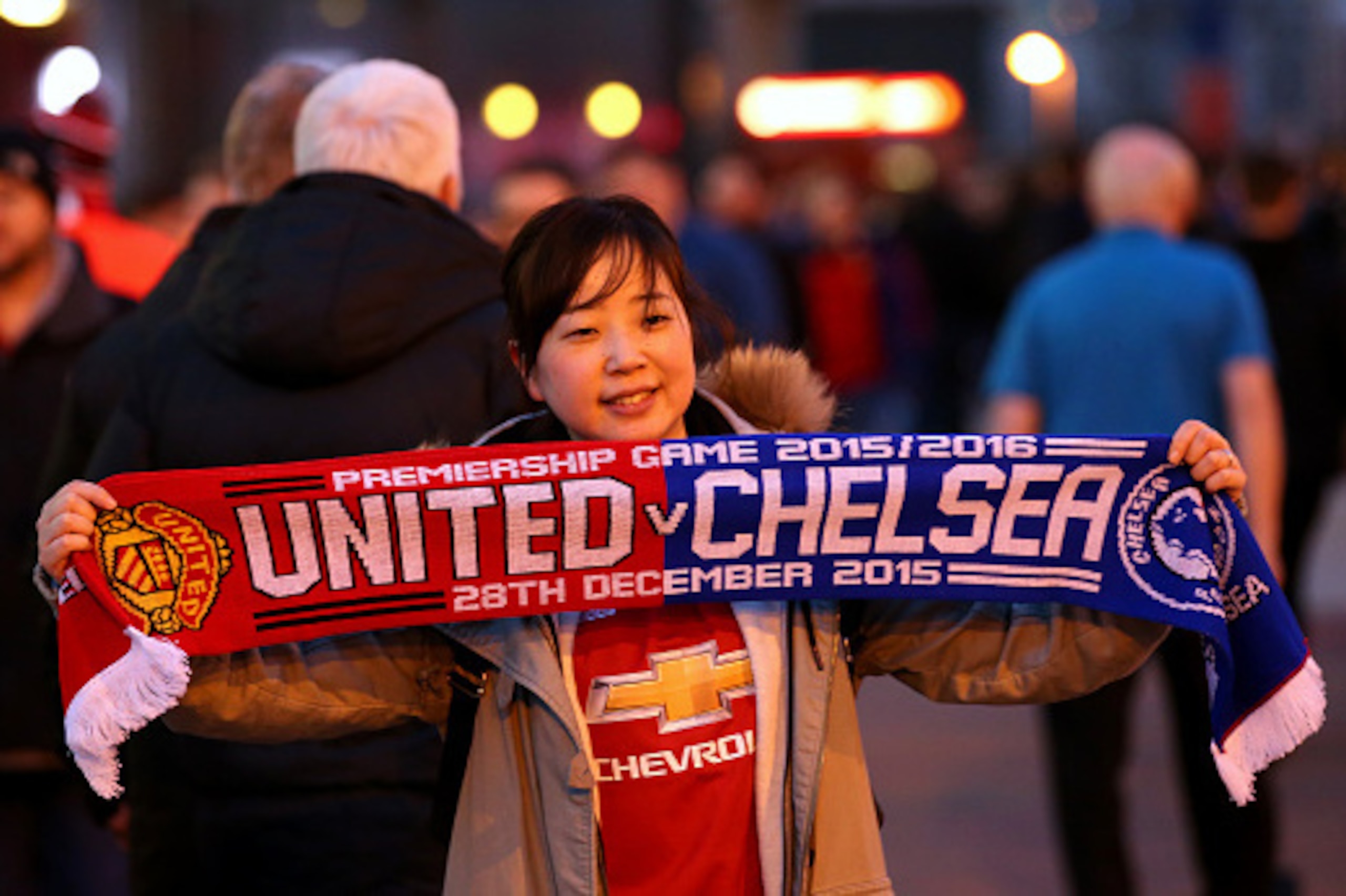 MANCHESTER, ENGLAND - DECEMBER 28:  A Manchester United fan poses with a scarf outside the stadium before the Barclays Premier League match between Manchester United and Chelsea at Old Trafford on December 28, 2015 in Manchester, England.  (Photo by Alex 