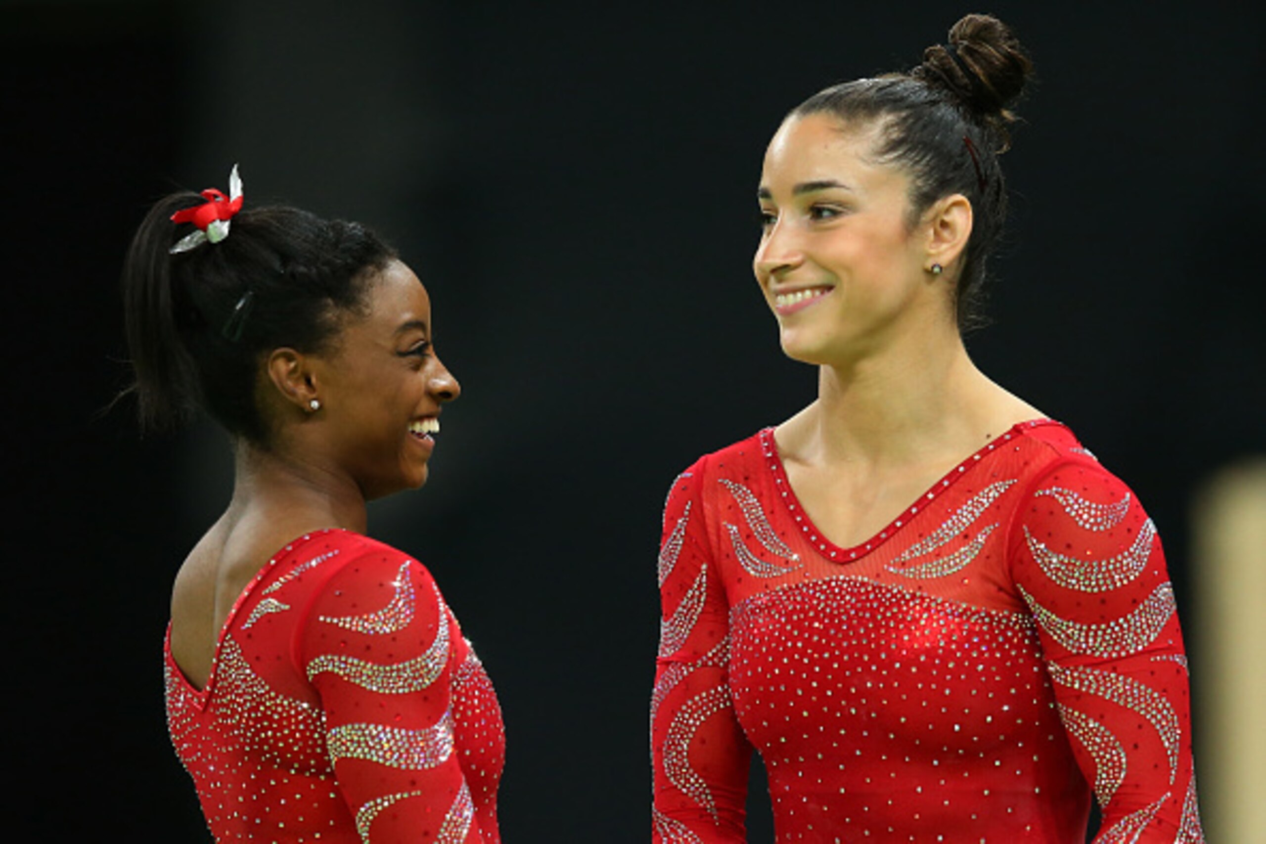 RIO DE JANEIRO, BRAZIL - AUGUST 04:  Aly Raisman and Simone Biles look on during an artistic gymnastics training session on August 4, 2016 at the Arena Olimpica do Rio in Rio de Janeiro, Brazil.  (Photo by Alex Livesey/Getty Images)