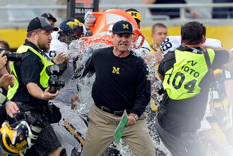 Jan 1, 2016; Orlando, FL, USA; Michigan Wolverines head coach Jim Harbaugh has water dumped on him after defeating Florida Gators to 41-7 to win the 2016 Citrus Bowl at Orlando Citrus Bowl Stadium. Michigan Wolverines defeated Florida Gators 41-7. Mandato