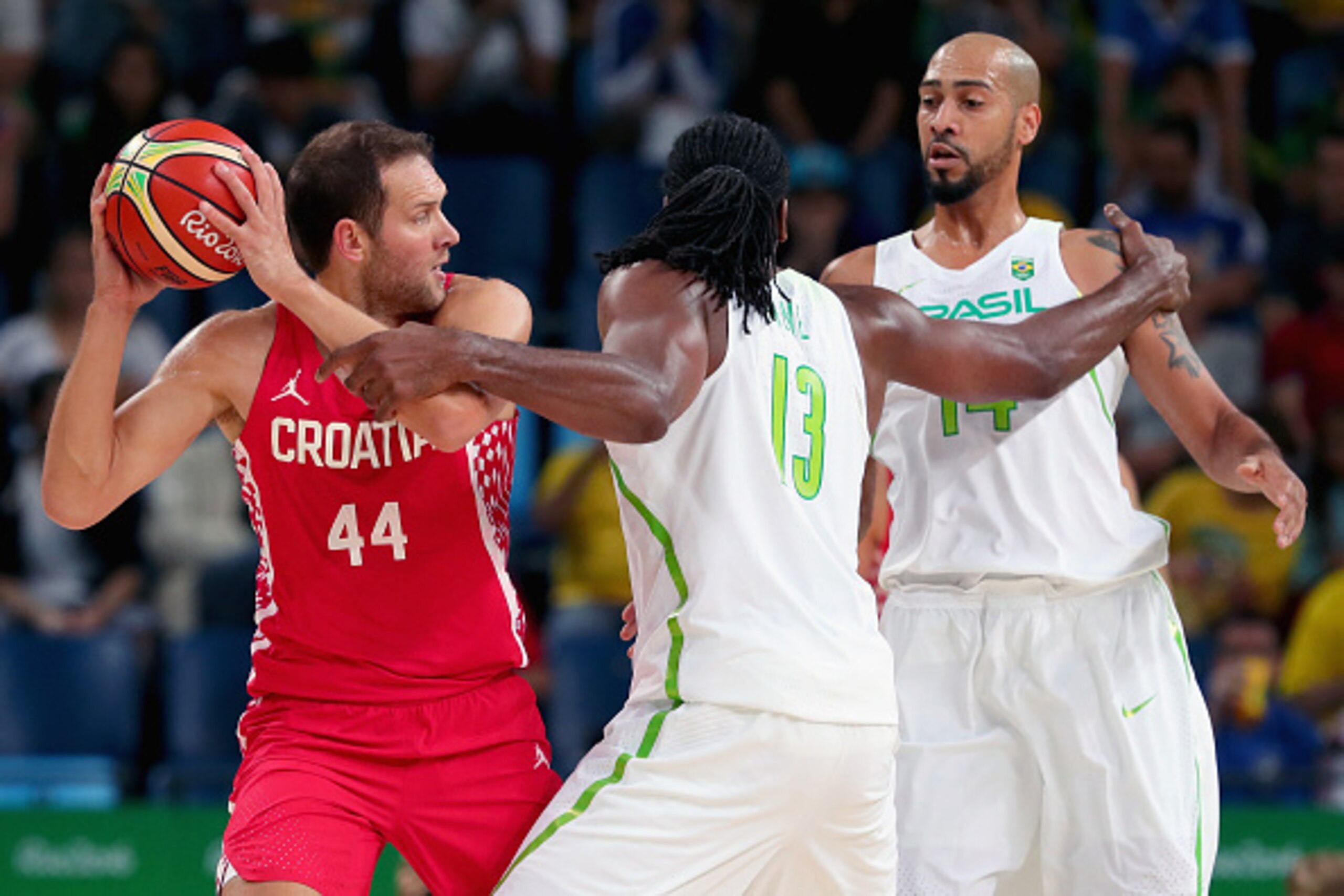 RIO DE JANEIRO, BRAZIL - AUGUST 11: Bojan Bogdanovic #44 of Croatia looks to pass the ball against Nene Hilario #13 of Brazil and Marcus Vinicius Marquinhos #14 of Brazil during the Men's Basketball - Preliminary Round Group B Brazil vs Croatia on Day 6 RIO DE JANEIRO, BRAZIL - AUGUST 11: Bojan Bogdanovic #44 of Croatia looks to pass the ball against Nene Hilario #13 of Brazil and Marcus Vinicius Marquinhos #14 of Brazil during the Men's Basketball - Preliminary Round Group B Brazil vs Croatia on Day 6